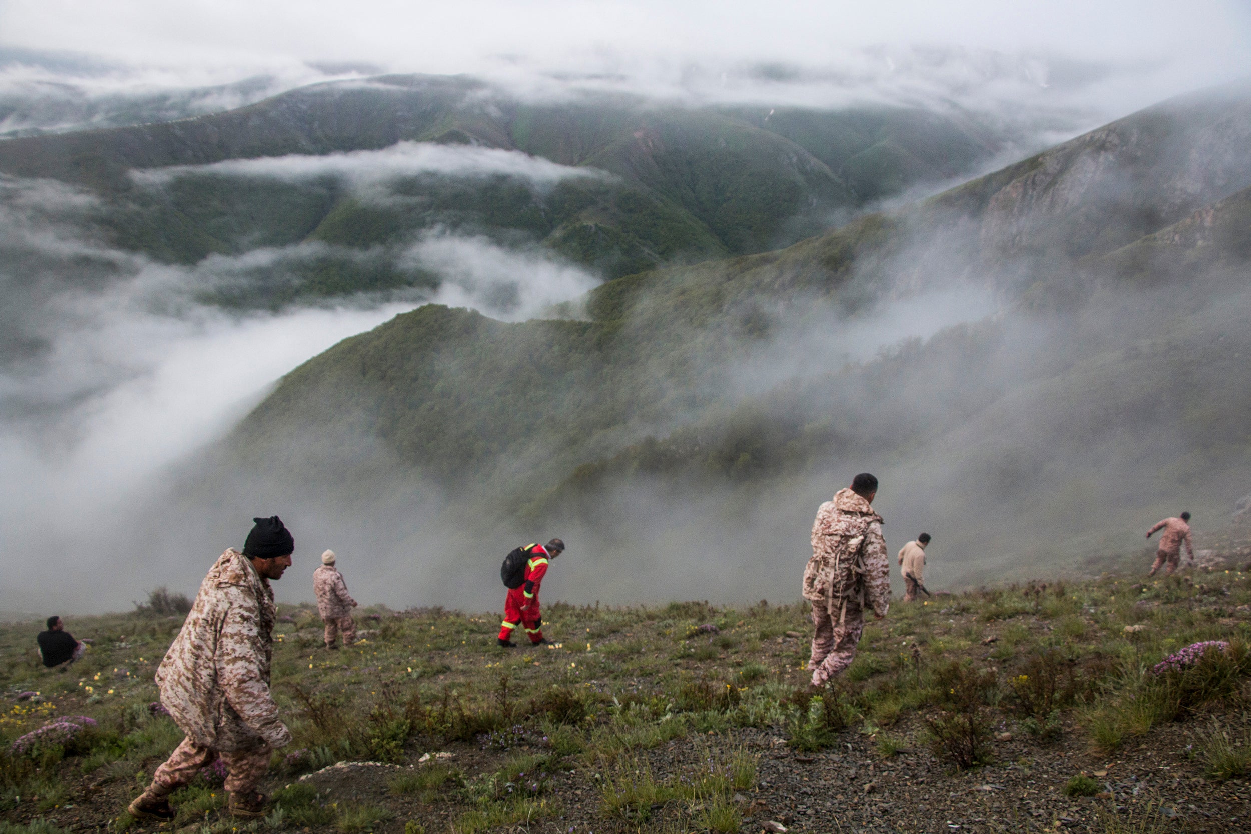 Rescue team members search an area near the crash site of a helicopter carrying Iranian president Ebrahim Raisi in Varzaghan, in northwestern Iran