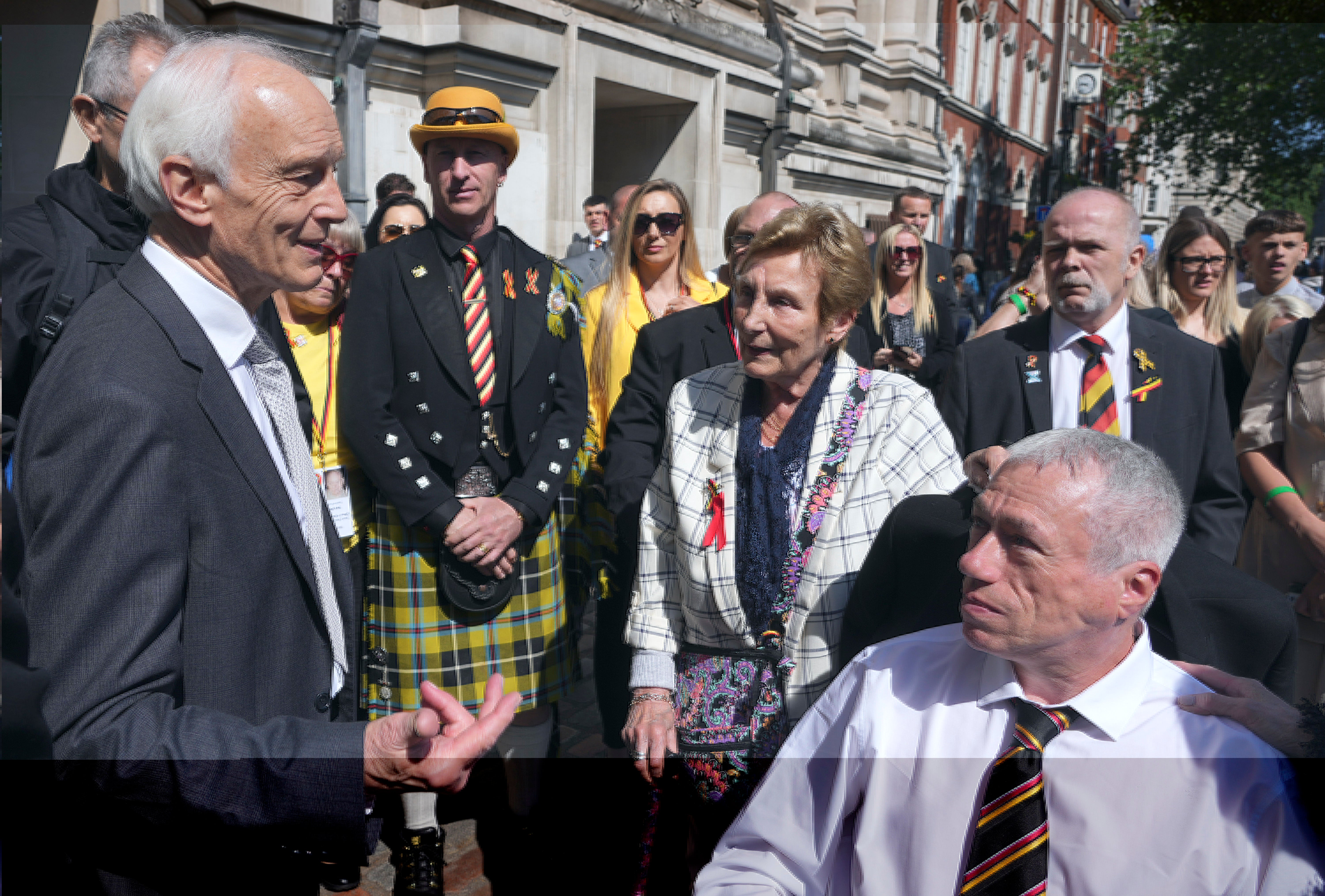 Chairman of the infected blood inquiry Sir Brian Langstaff with victims and campaigners outside Central Hall