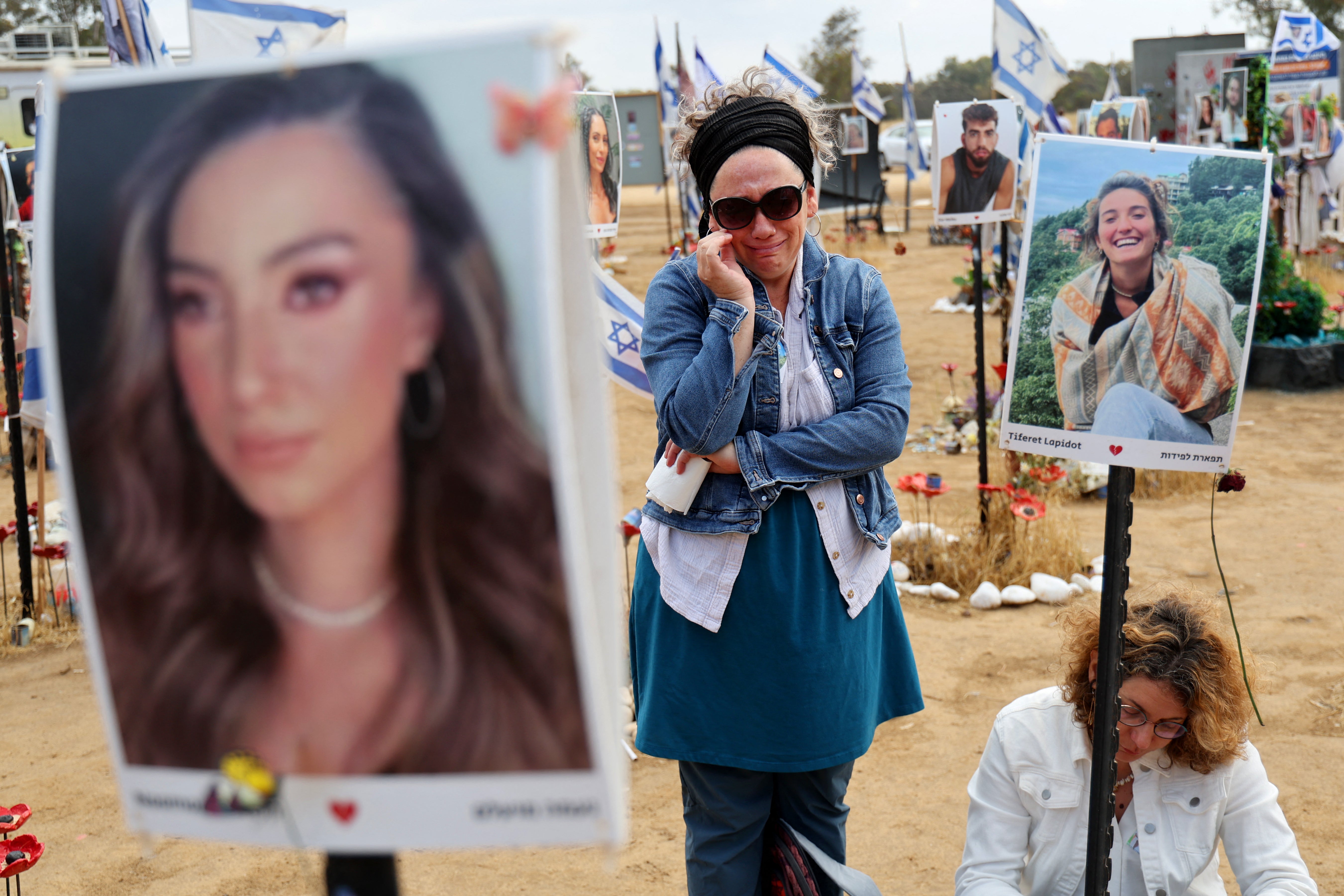 Visitors at a memorial for those taken hostage or killed in the Hamas attack on the Supernova music festival on 7 October