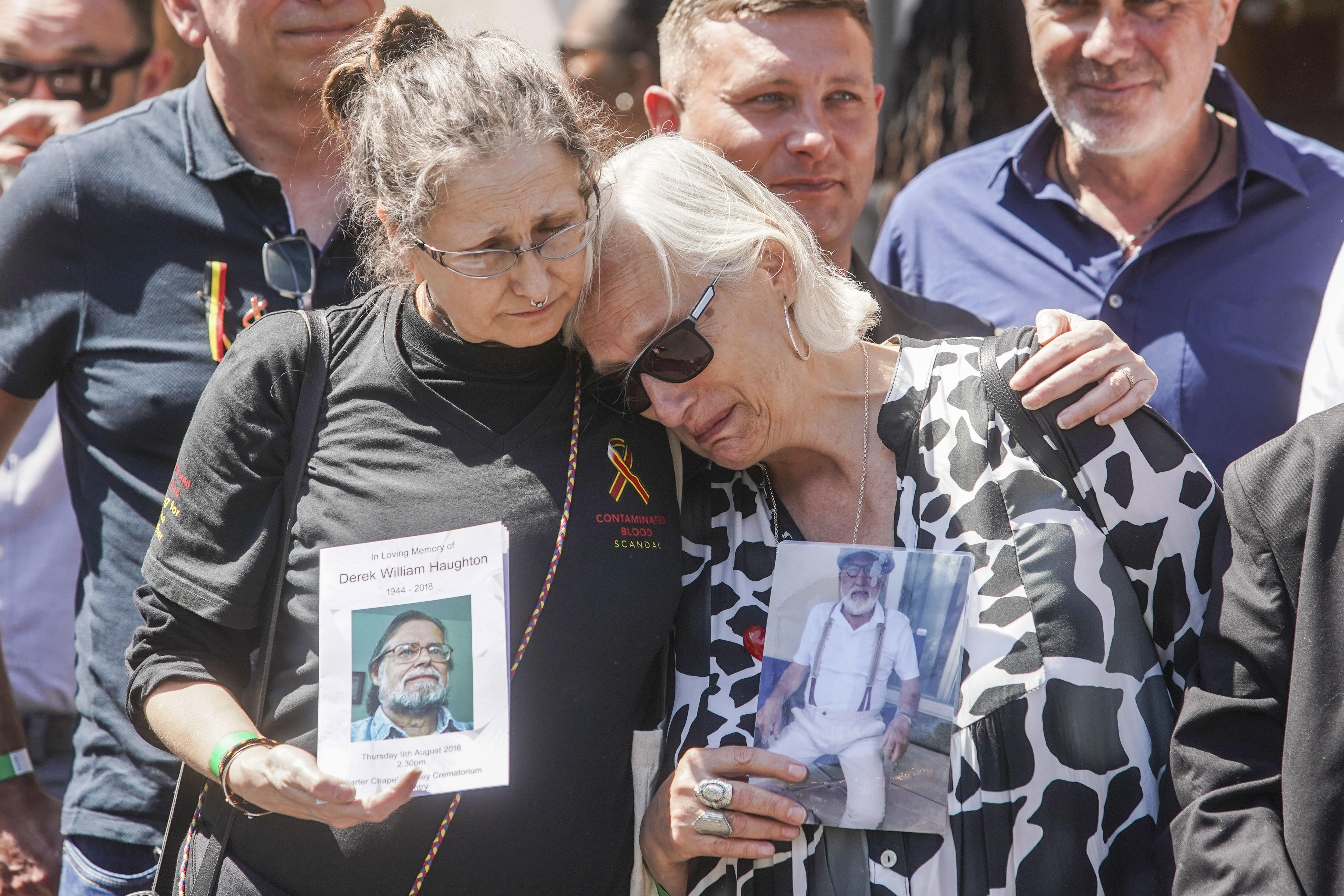 Cressida Haughton, whose father died, and Deborah Dennis, whose husband died, outside Central Hall in Westminster