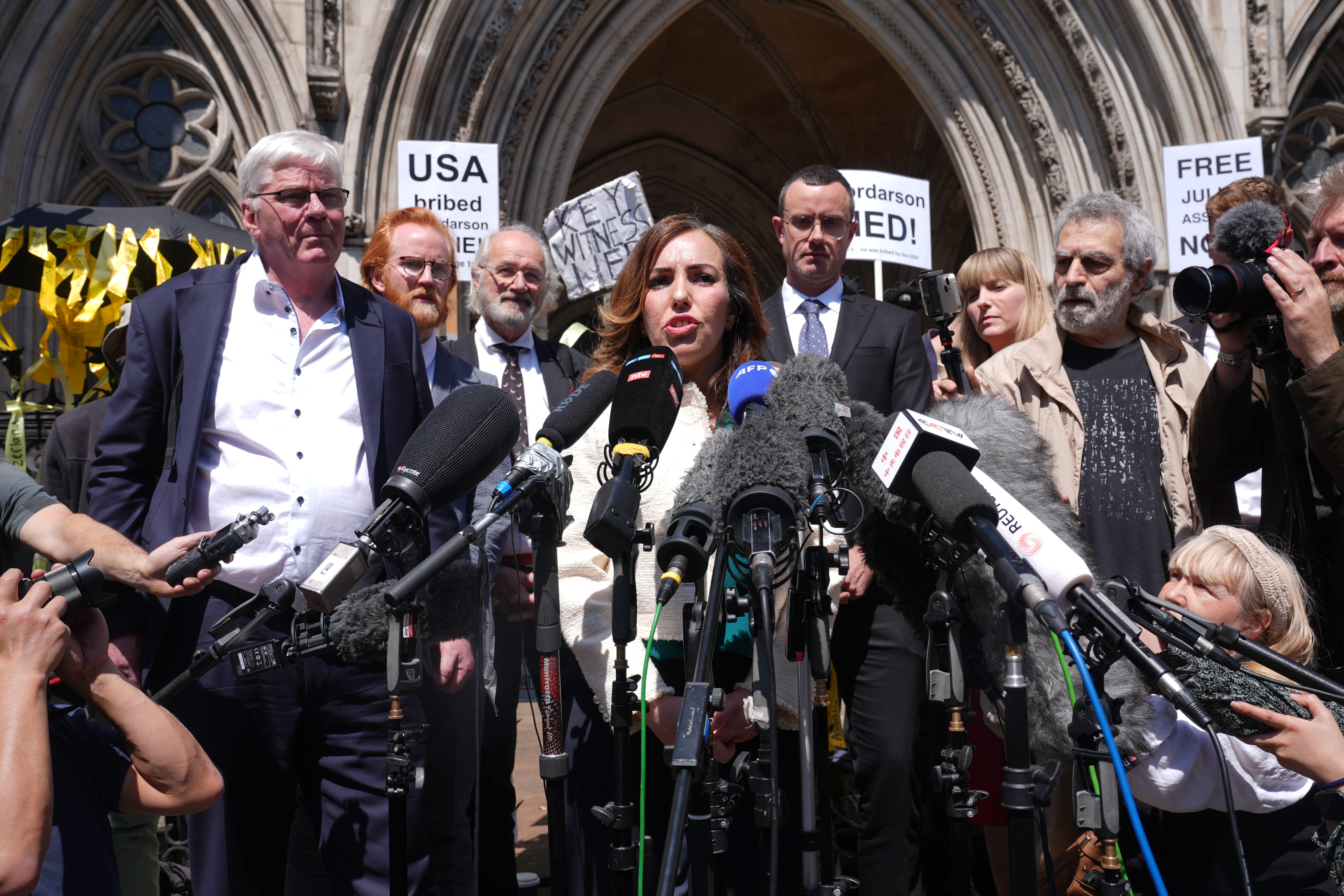 Stella Assange, the wife of Julian Assange, gives a statement outside the Royal Courts of Justice in London, after he won a bid at the High Court to bring an appeal against his extradition to the US (Lucy North/PA)