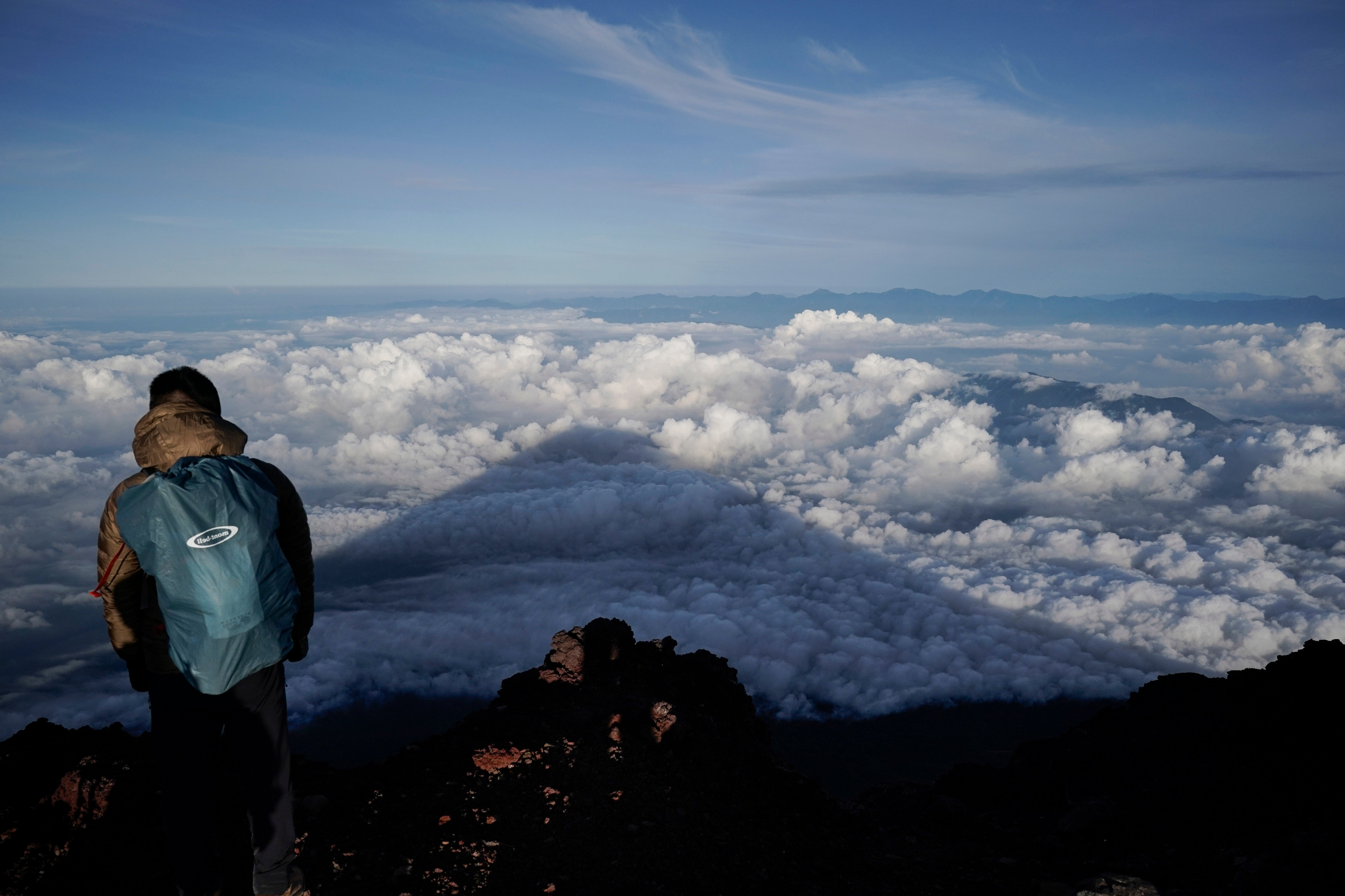 The shadow of Mount Fuji is casted on clouds hanging below the summit