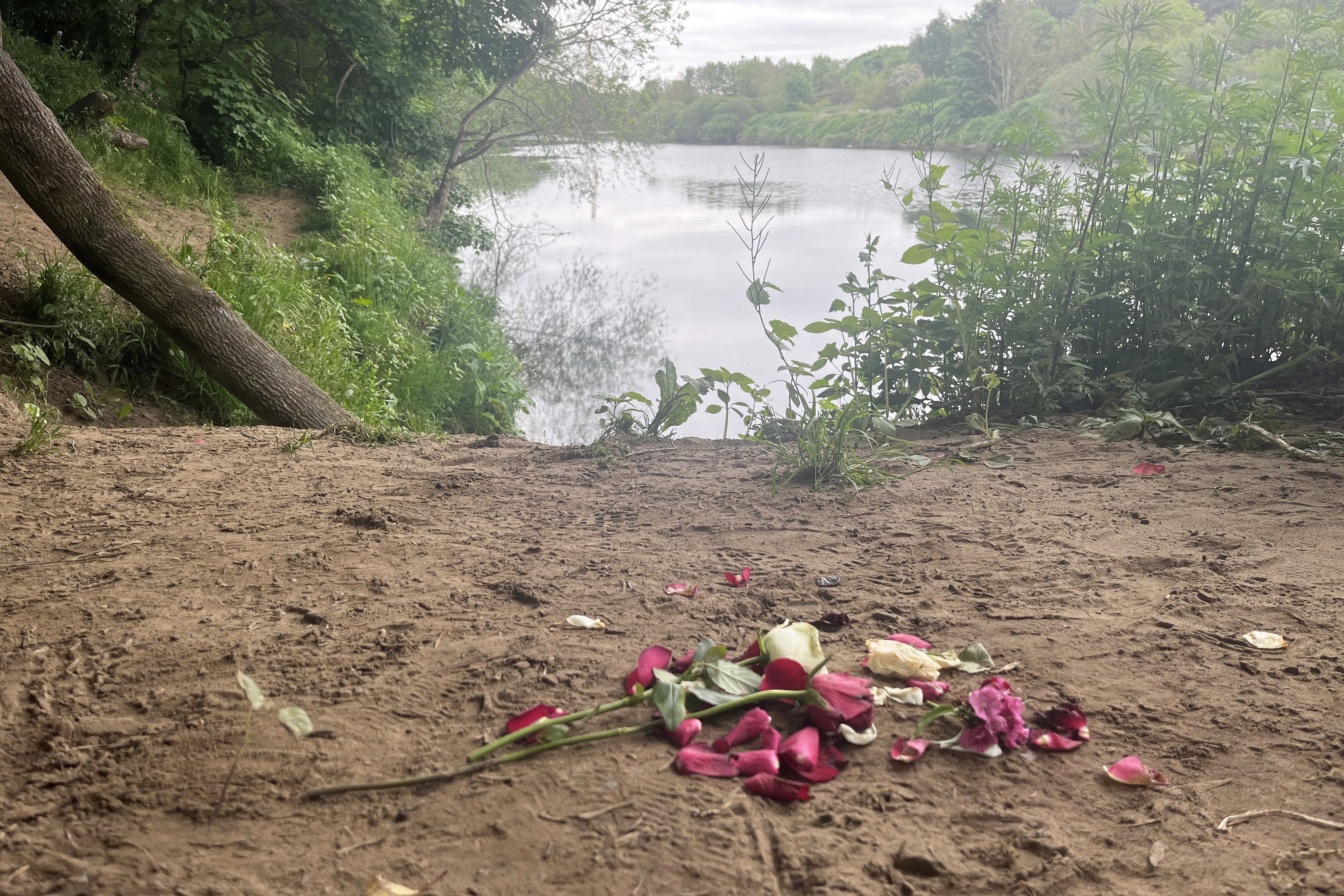 Flowers are left on the bank of the River Tyne at Ovingham, Northumberland (Tom Wilkinson/PA)