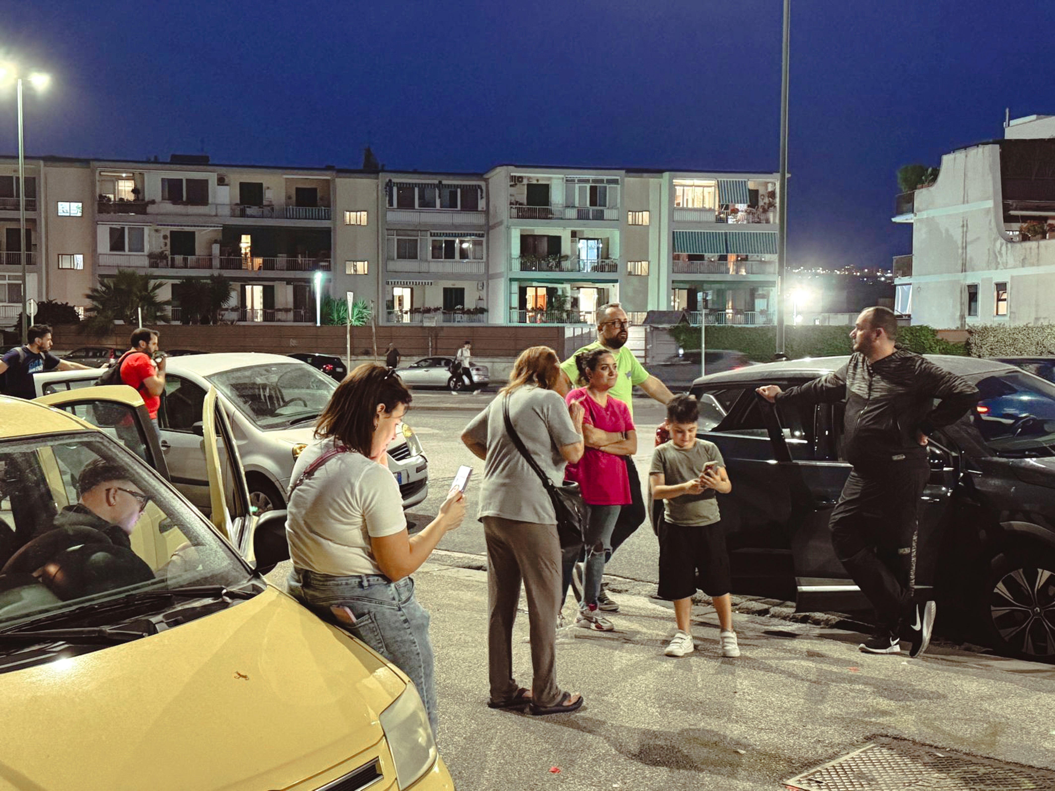 People gather in a street after an earthquake in Campi Flegrei, near Naples, Italy, Tuesday, May 20, 2024