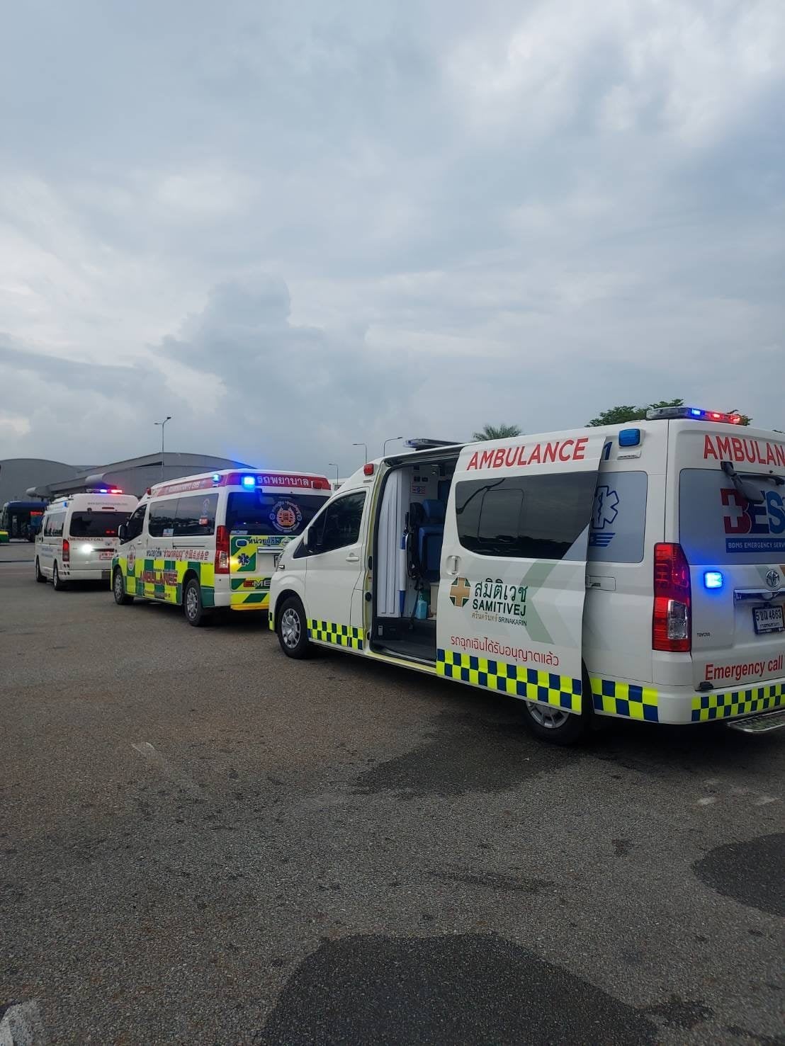 Ambulances at Bangkok airport treating injured passengers