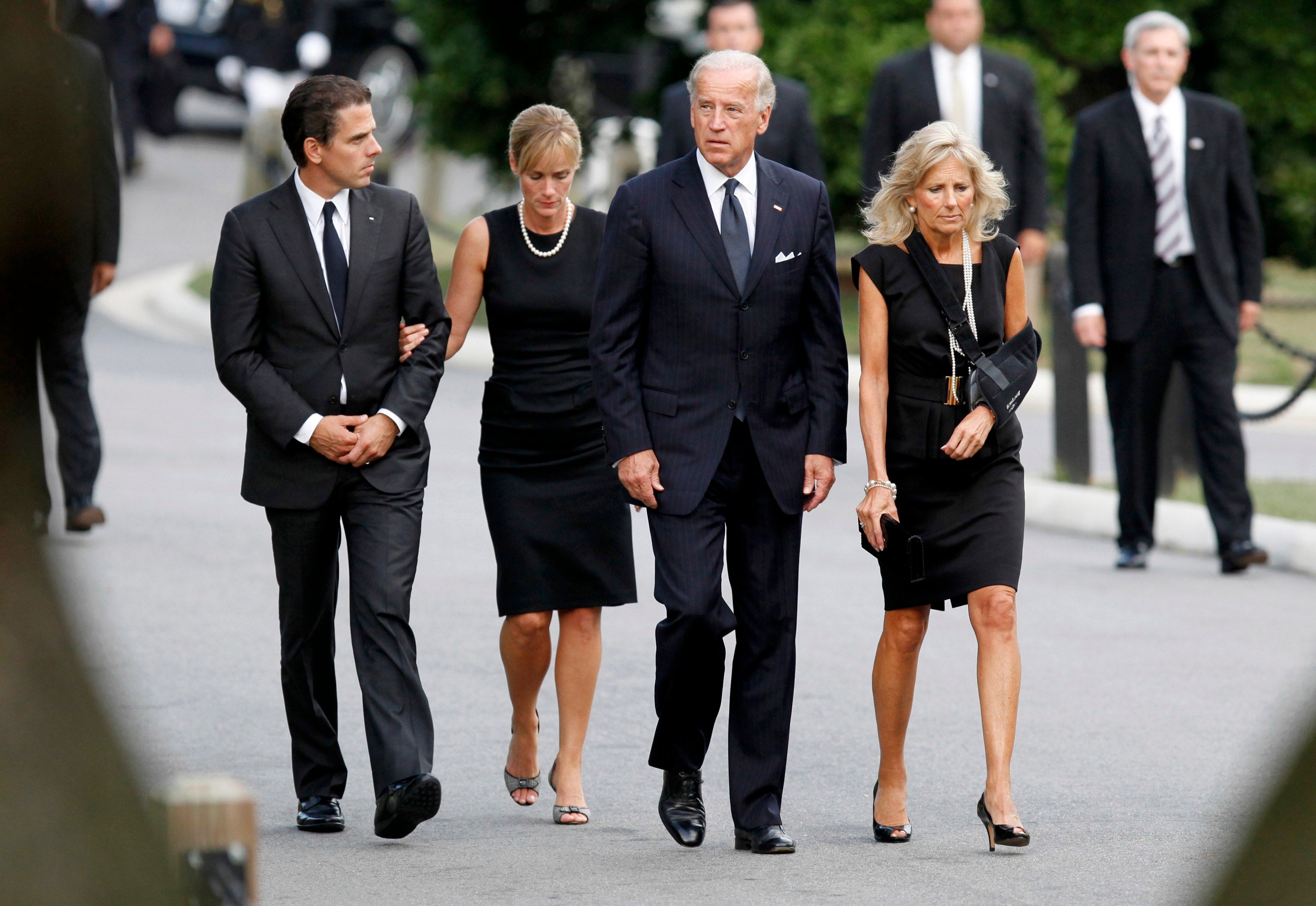 Hunter Biden (far left) walks with his wife Kathleen Buhle (center left) while attending the trial of Senator Edward Kennedy on 29 August 2009