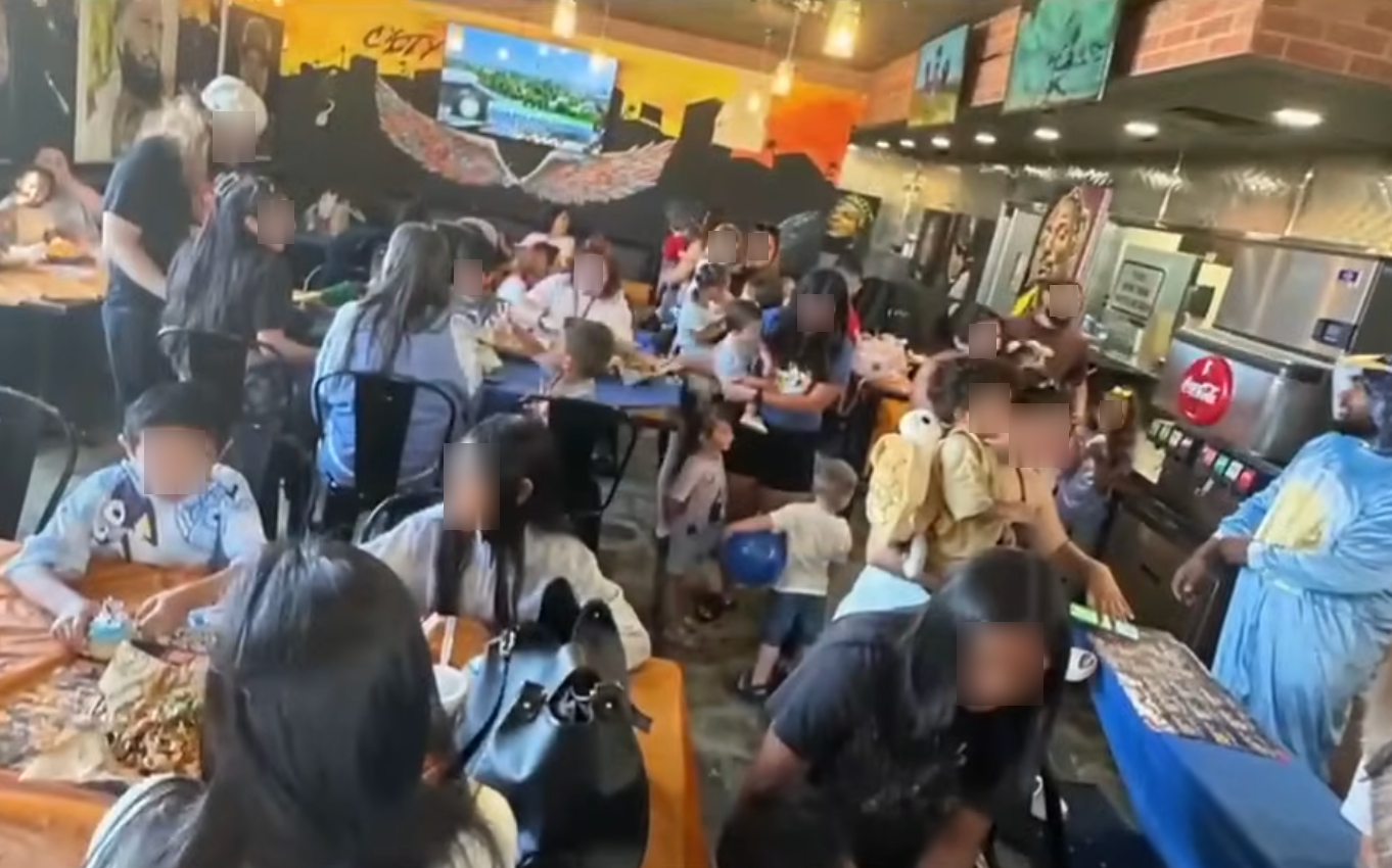 Parents and kids sitting inside the restaurant for the Bluey celebration