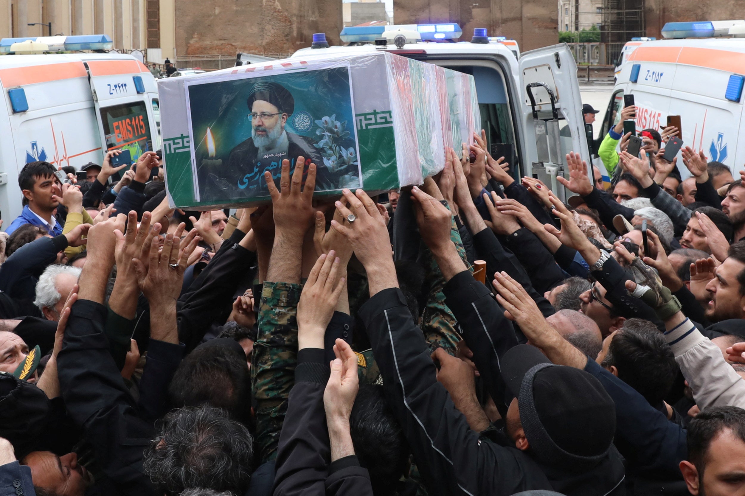 People carry the coffin of the late Iranian President Ebrahim Raisi, during his funeral ceremony in Tabriz, East Azerbaijan Province, Iran