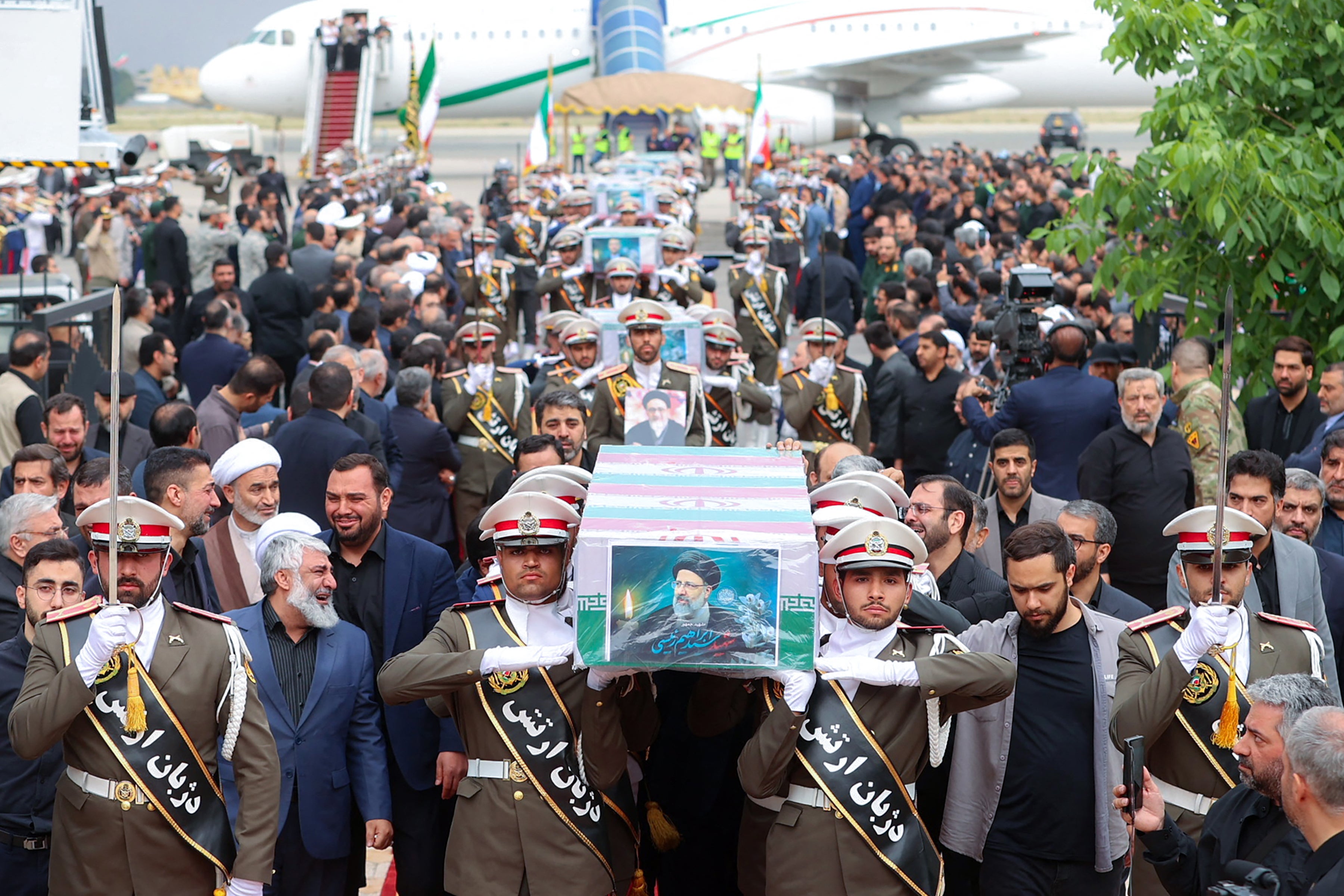 Soldiers carry the coffin of the late Iranian President Ebrahim Raisi at Mehrabad Airport in Tehran