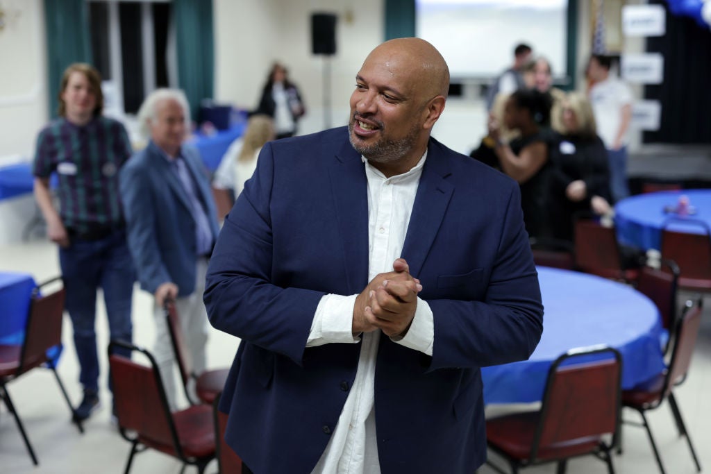 Harry Dunn, a former Capitol Police officer, greets supporters at an election night watch party on 14 May 2024