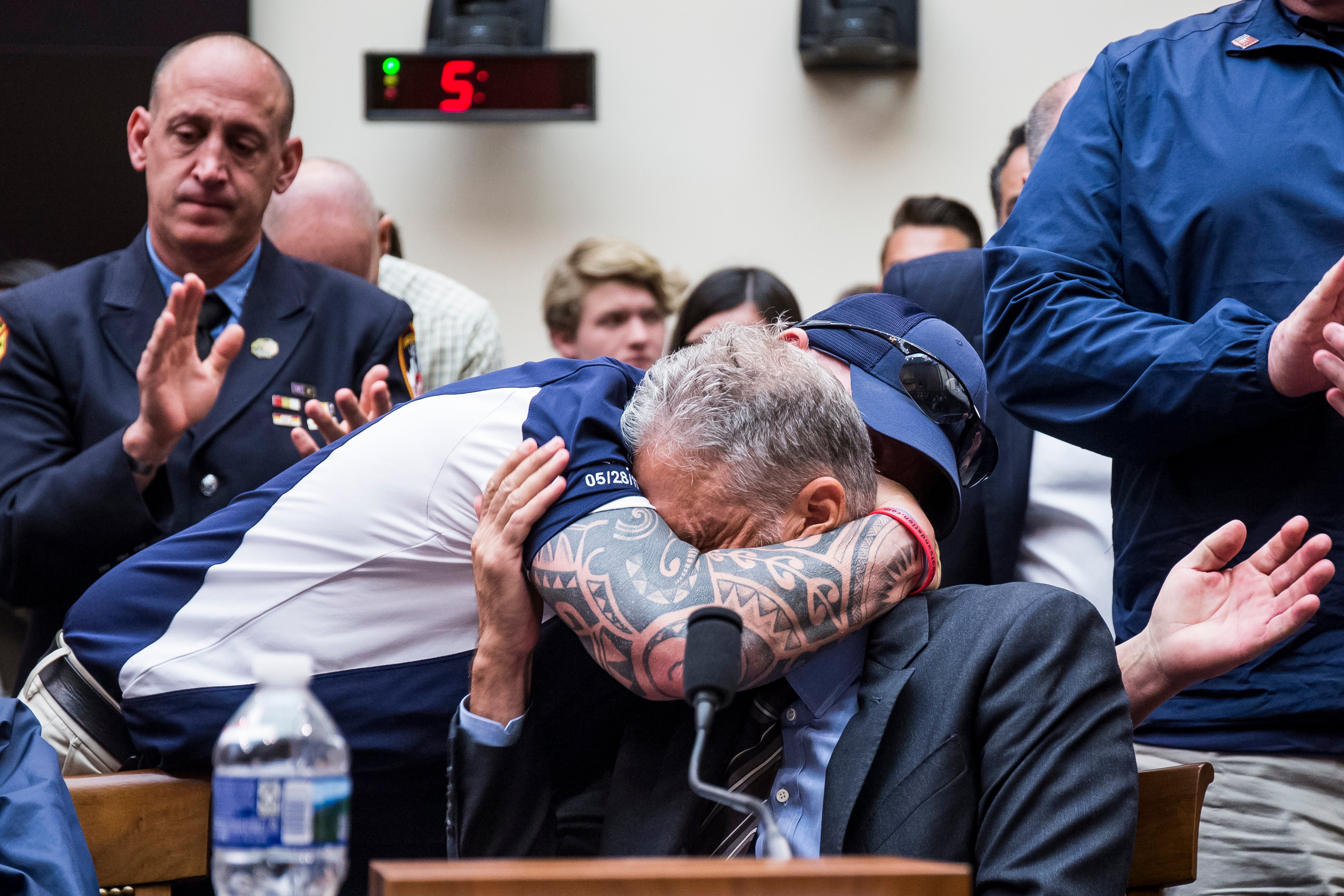 John Feal hugs Stewart during a House Judiciary Committee hearing on reauthorization of the September 11th Victim Compensation Fund in 2019