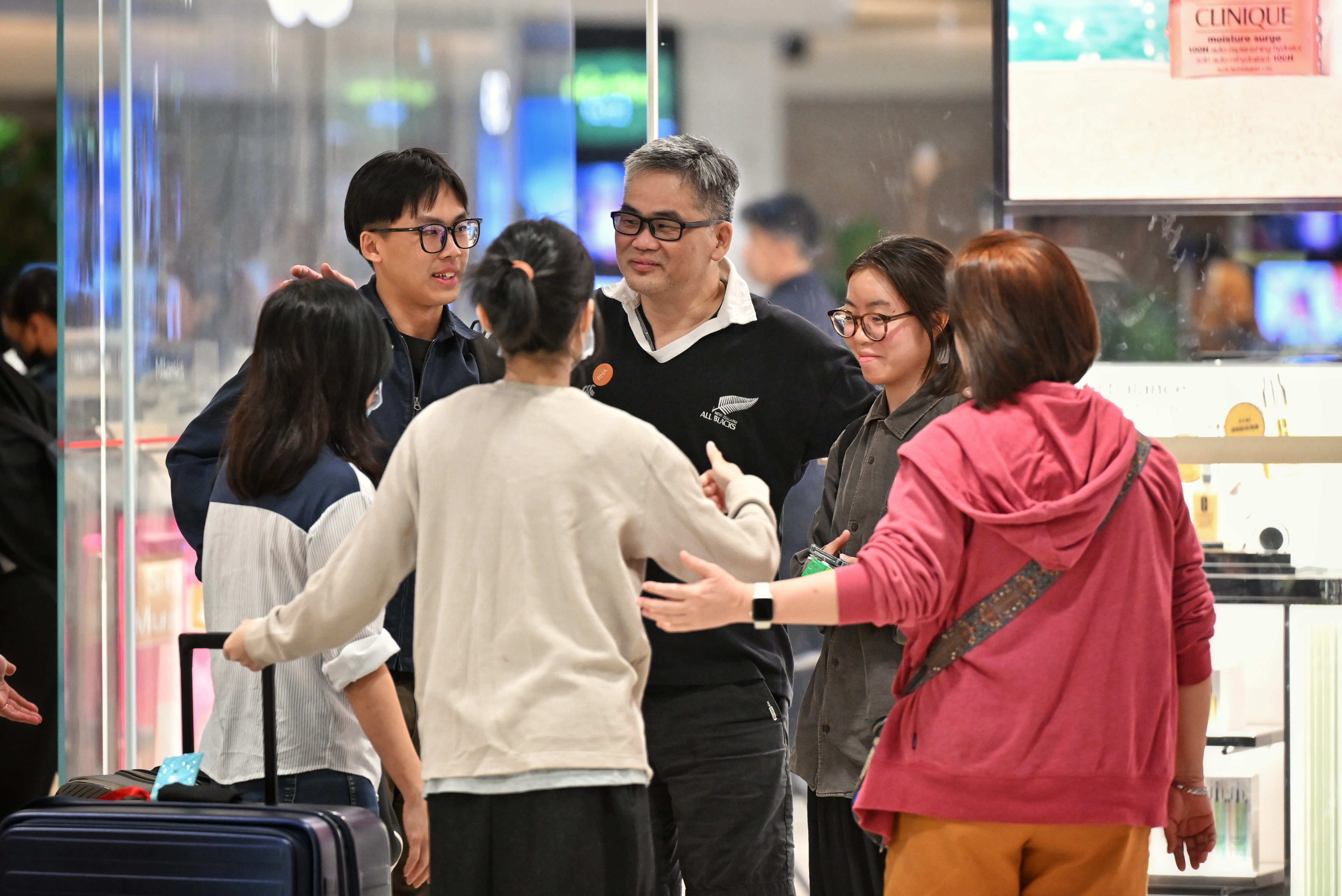 Passengers of Singapore Airlines flight SQ321, which made an emergency landing in Bangkok on its flight from London to Singapore, greet family members upon arrival at Changi Airport in Singapore, 22 May 2024