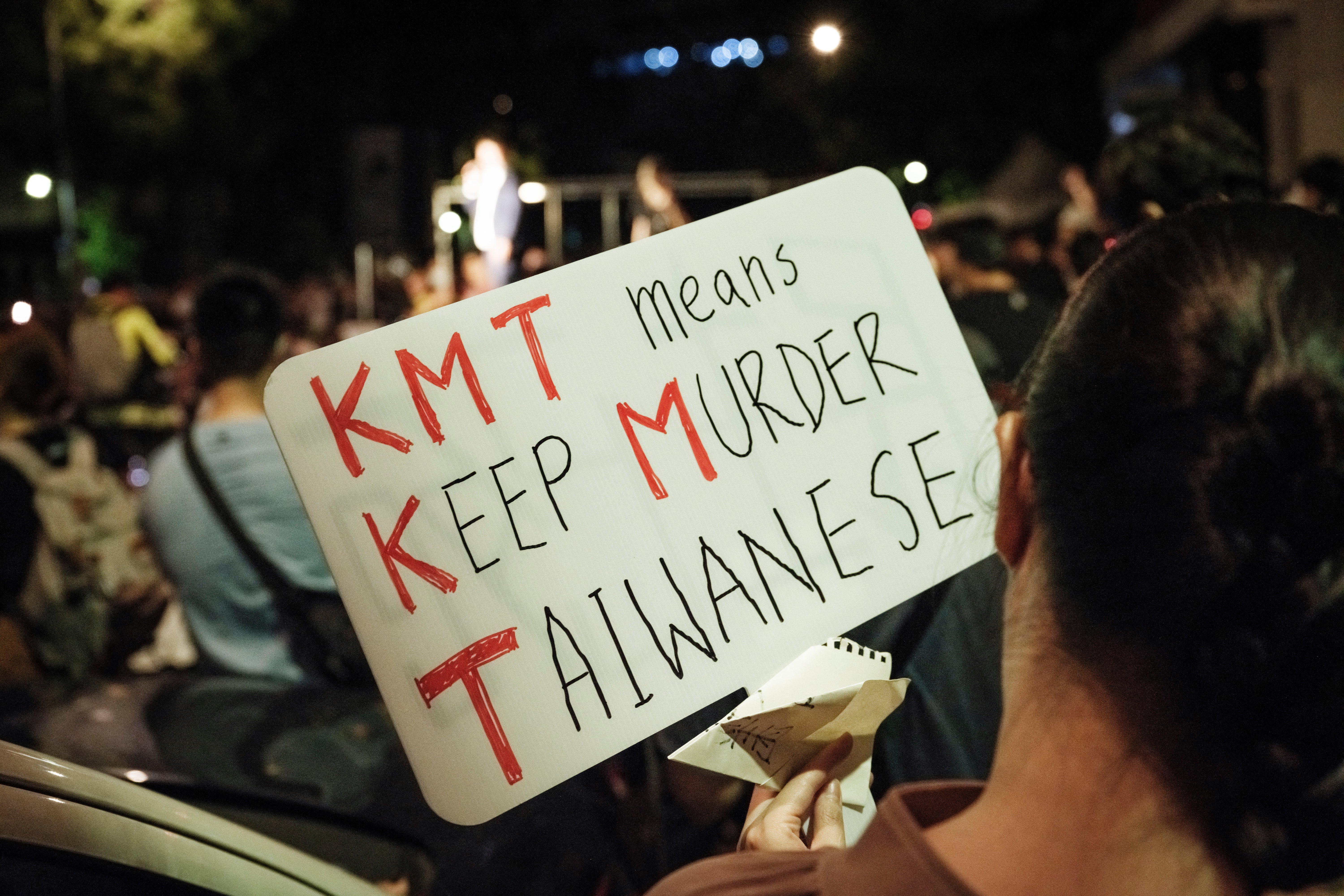 A protester holds a placard outside the Legislative Yuan in Taipei