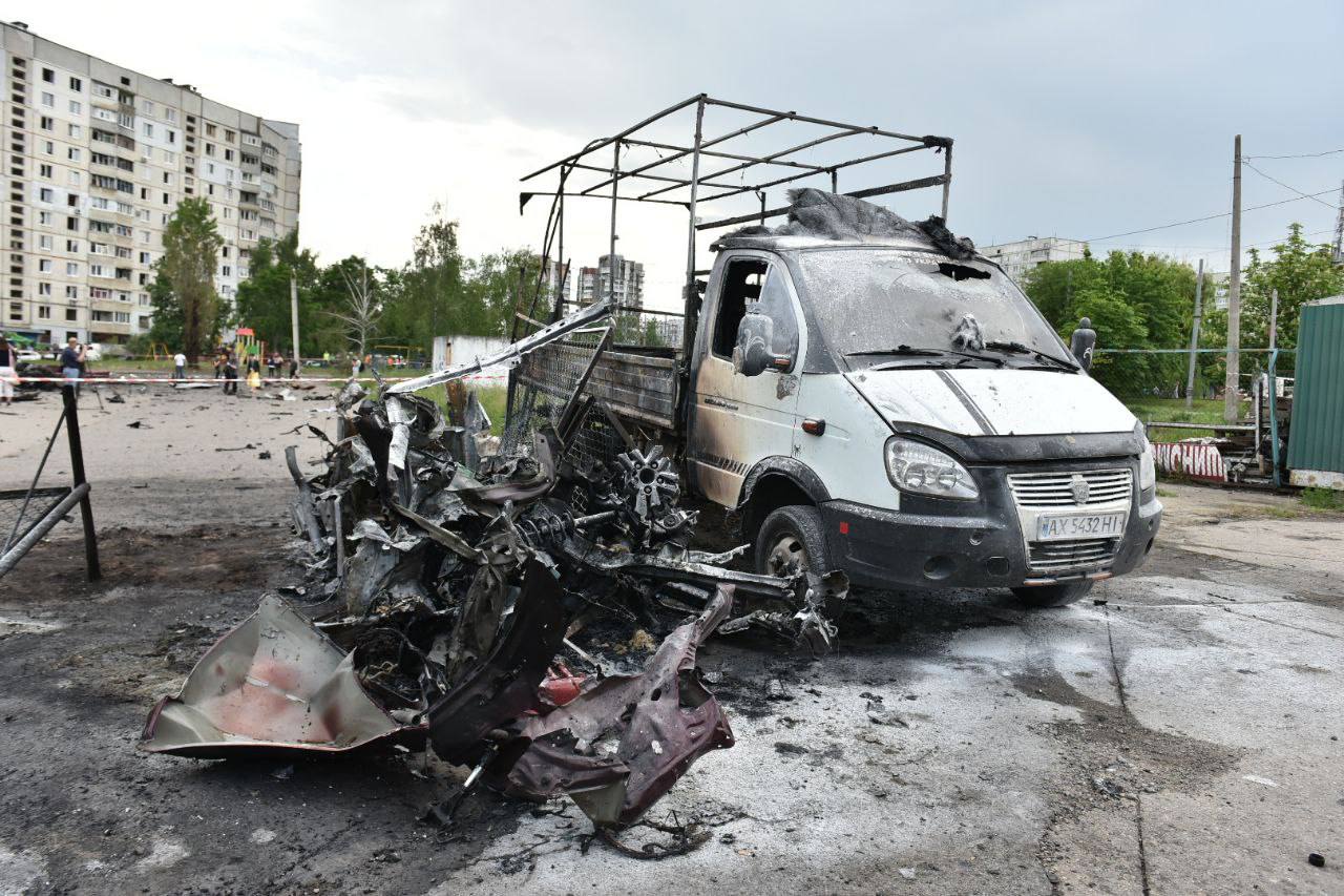 A white van is completely destroyed by a Russian glide bomb attack in Kharkiv, as a building seen behind has its windows blown out