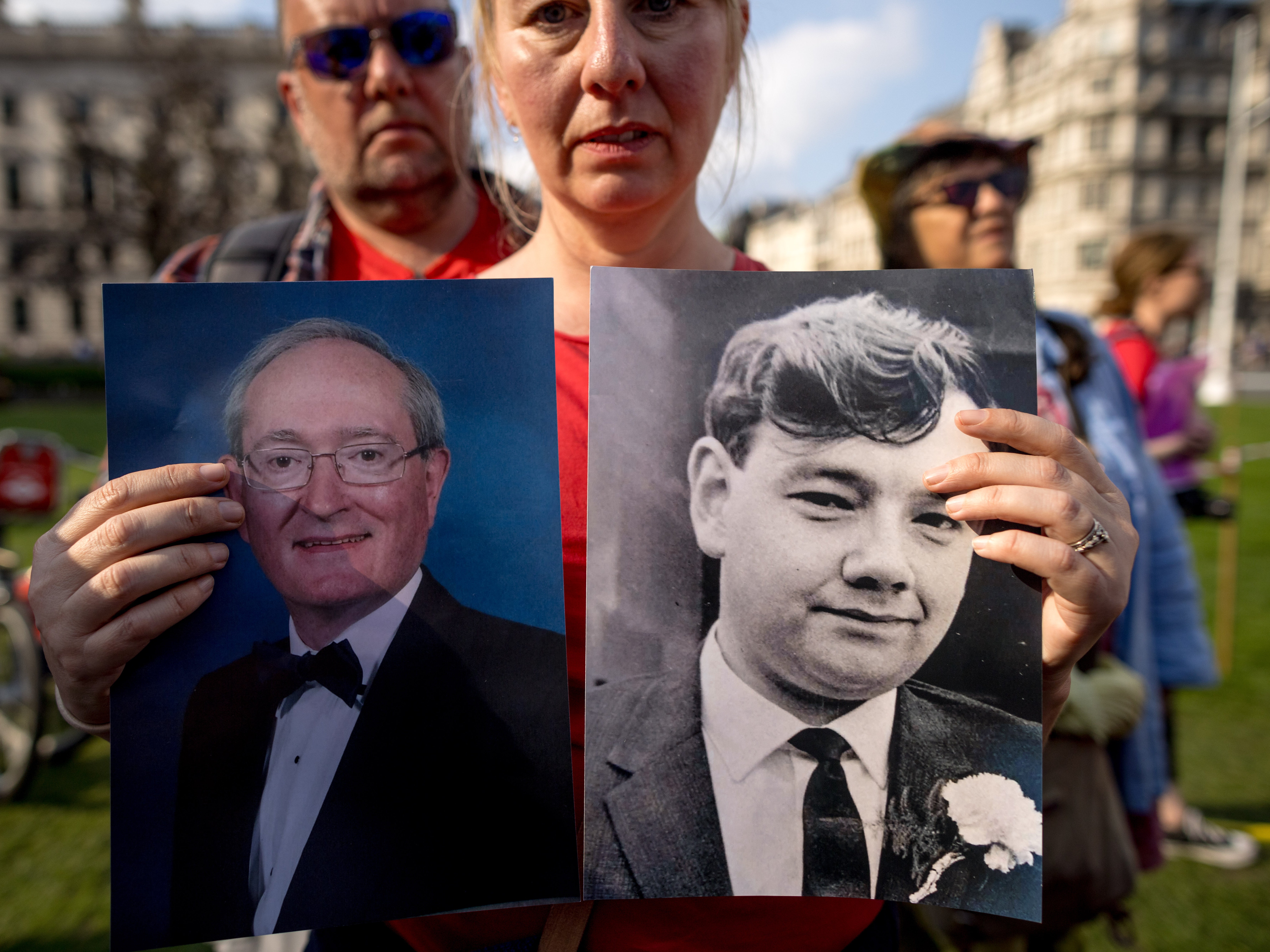 Toni Poole holds up pictures of her father Anthony Higgs (right) and her stepfather Tony Owen (left), who both died after receiving infected blood