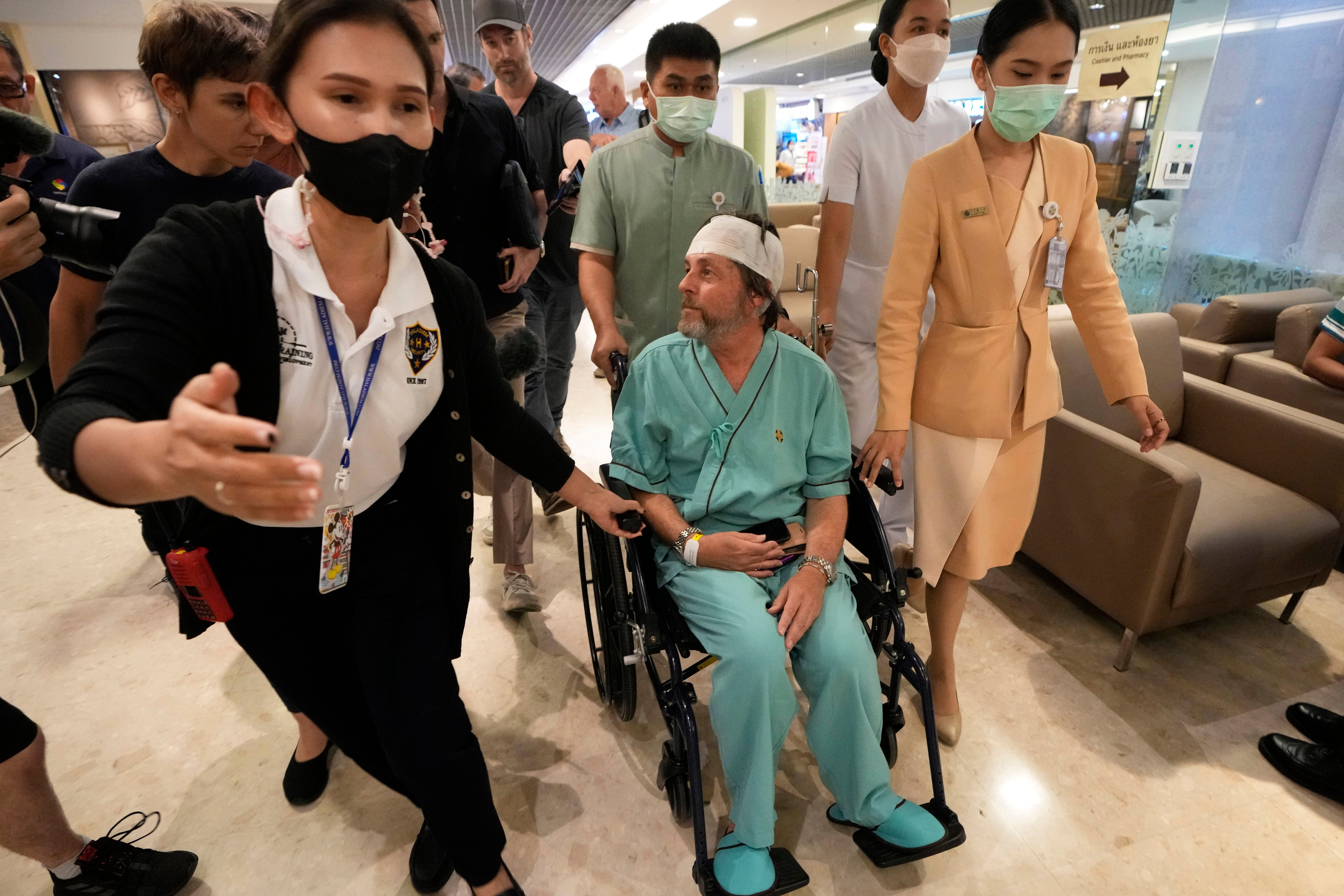 An injured Australian passenger on Singapore Airlines flight SQ321 talks to reporters at Samitivej Srinakarin Hospital in Bangkok, Thailand