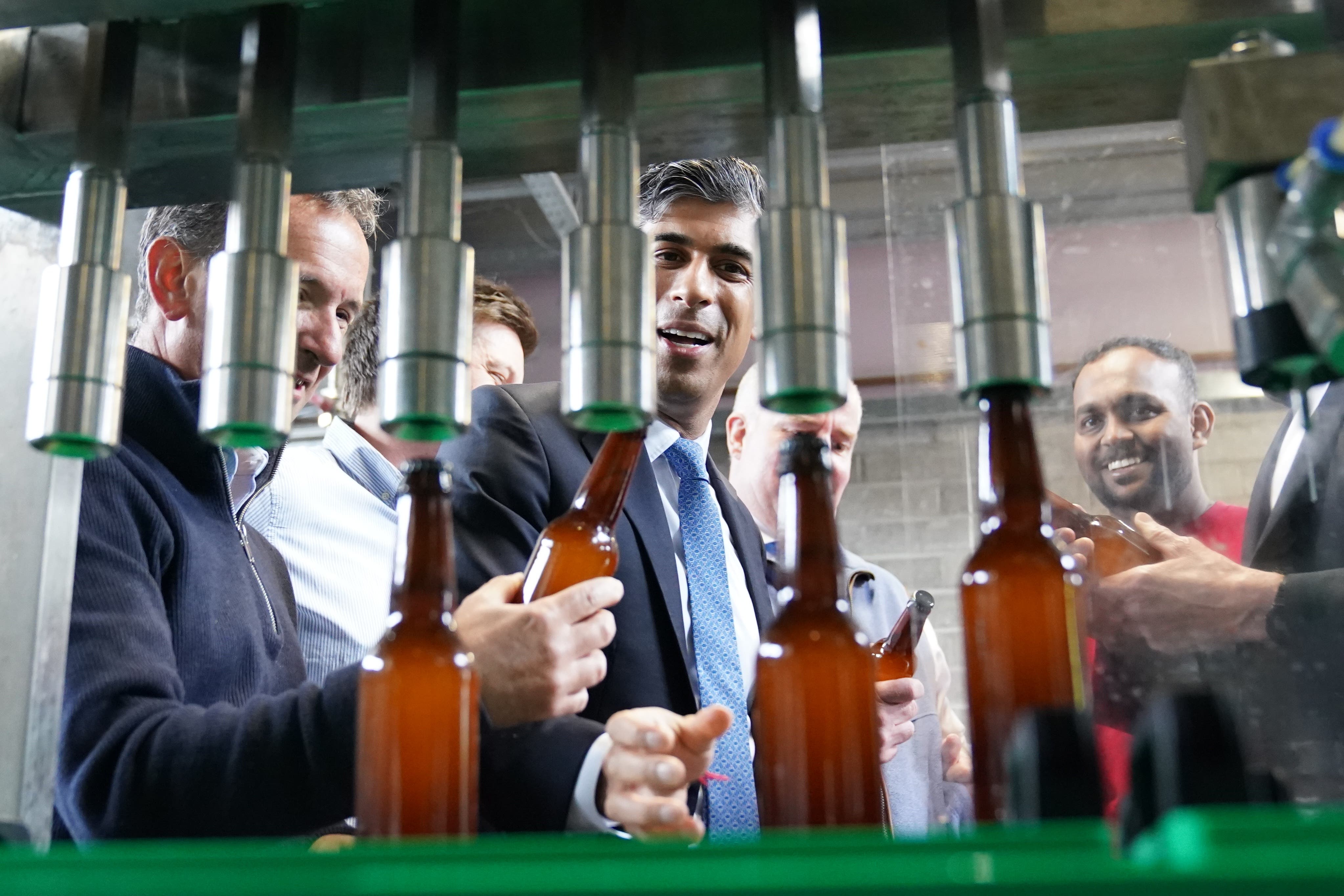 Prime Minister Rishi Sunak watching beer being bottled at the Vale of Glamorgan Brewery (Stefan Rousseau/PA)