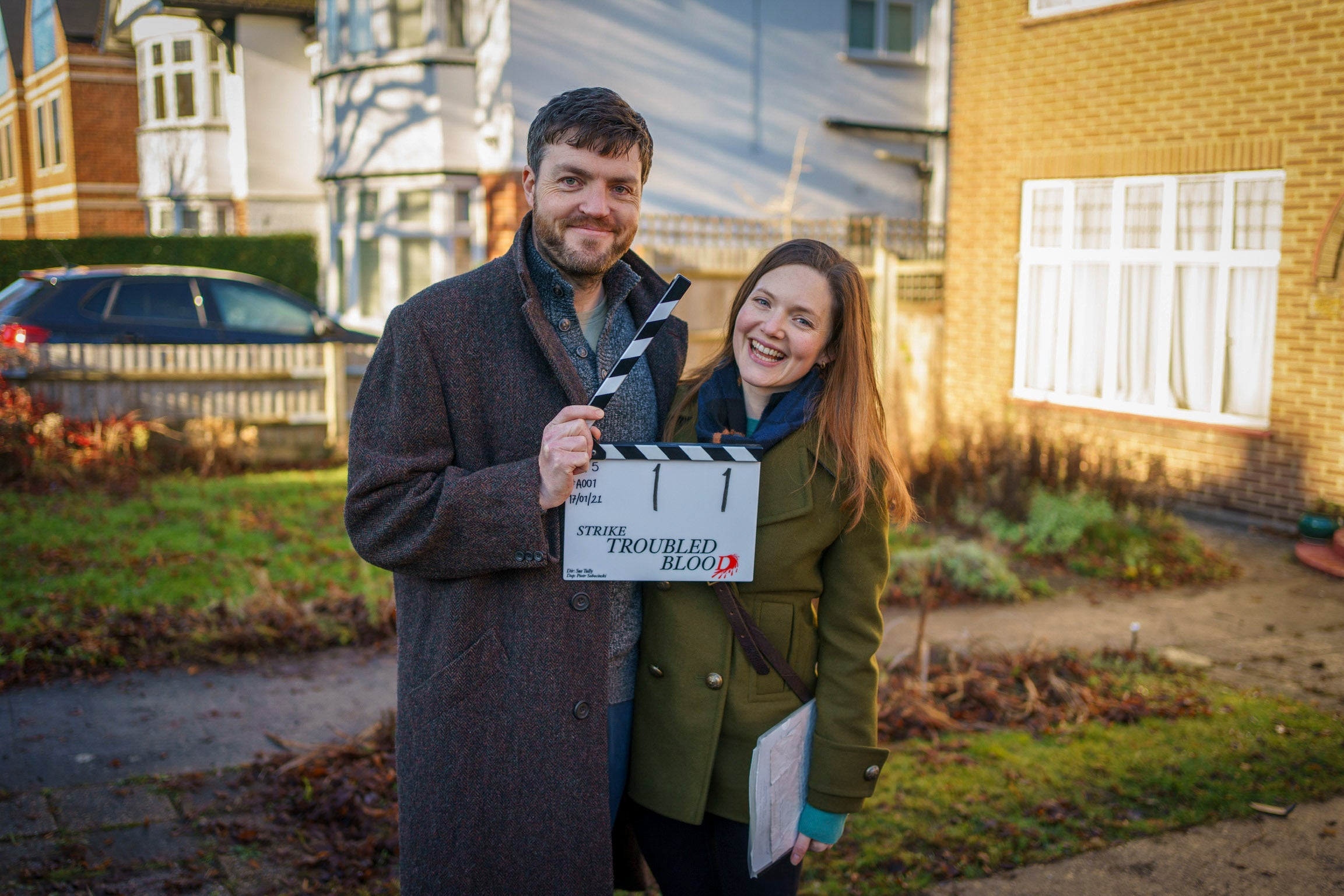 Burke and his co-star Holliday Grainger on the set of ‘Strike’ in 2022