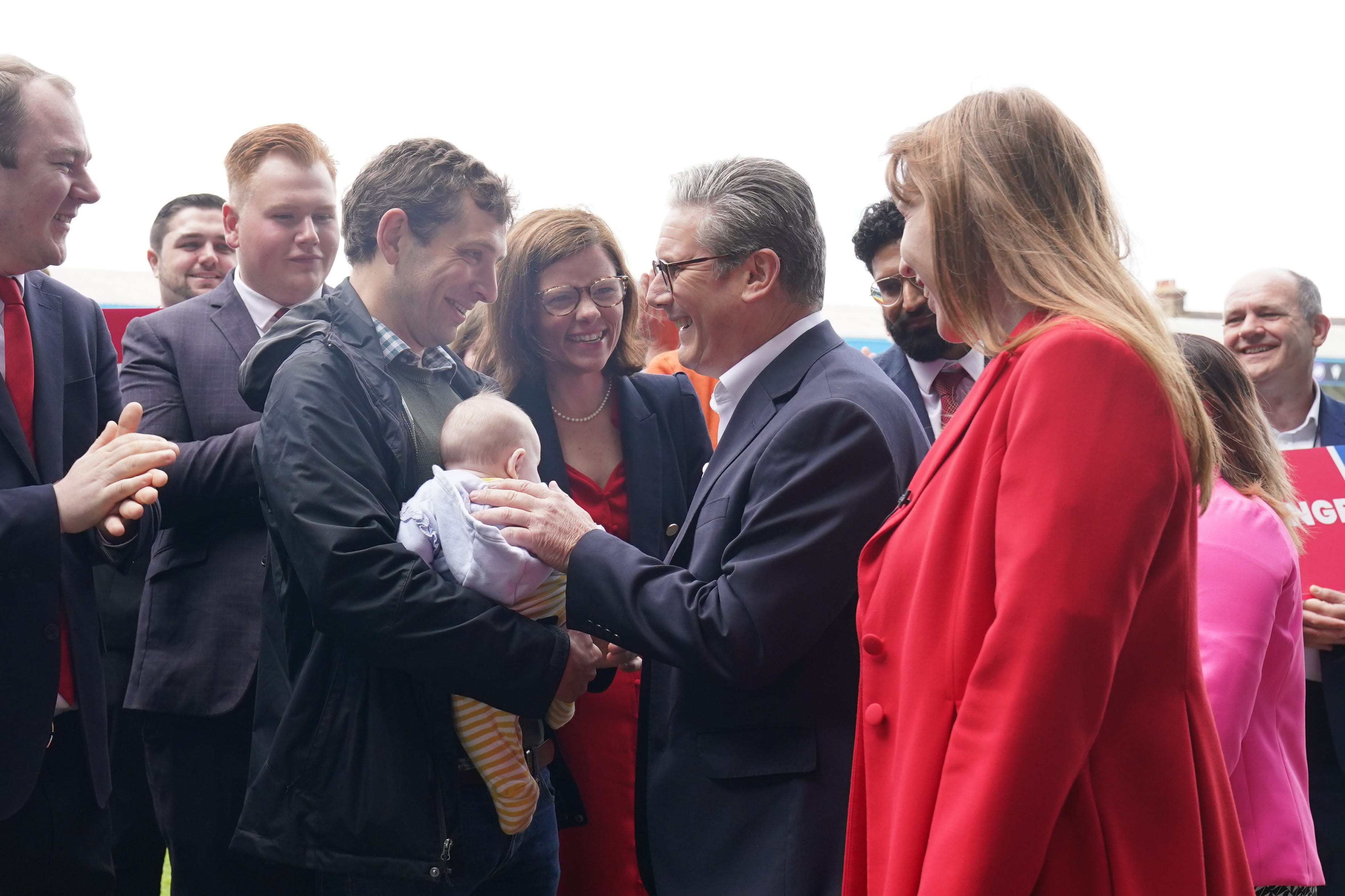 A traditional part of the election trail, Labour leader Sir Keir Starmer greets a very young supporter in Kent (Gareth Fuller/PA)