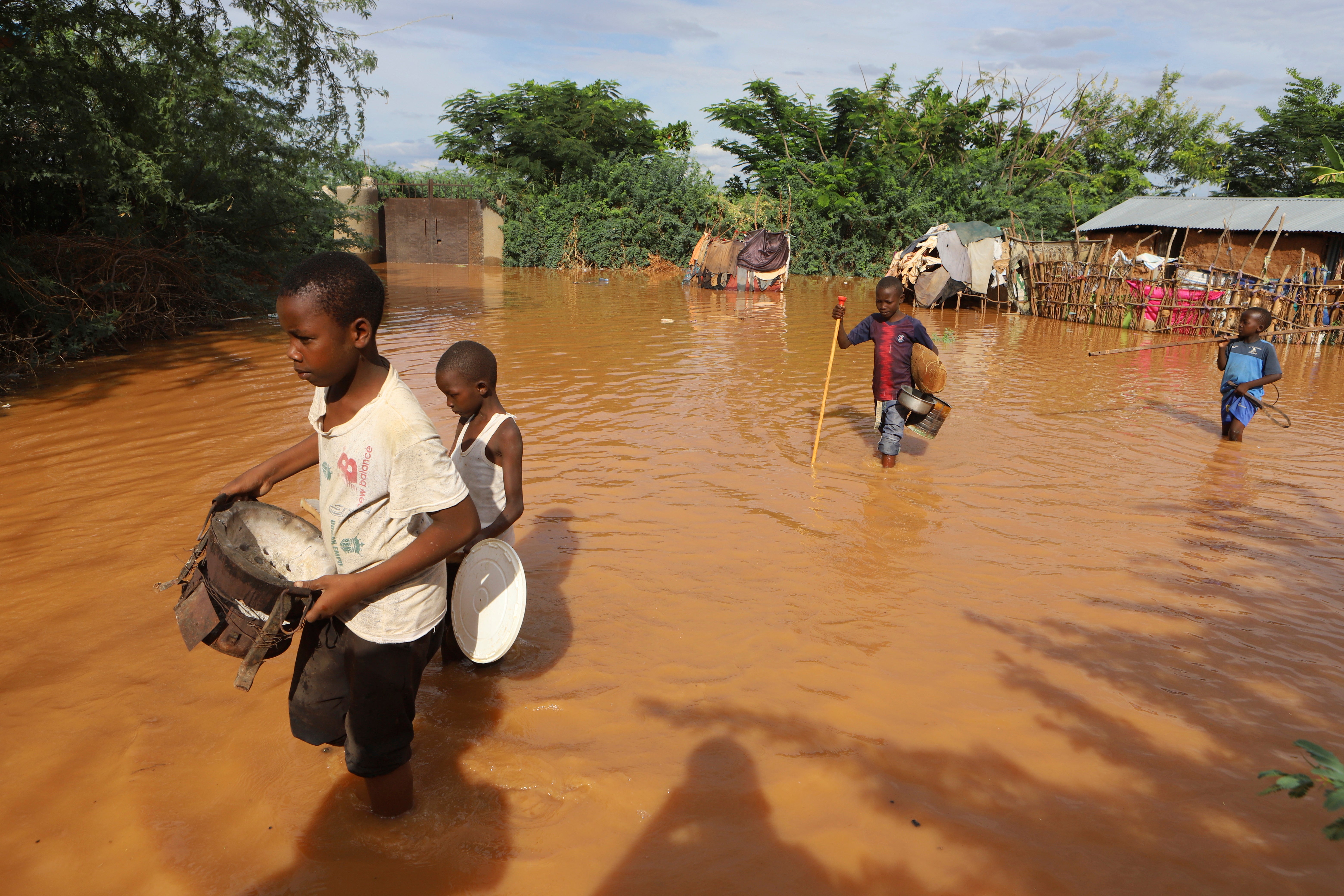 Children flee floodwaters that wreaked havoc at Mororo, border of Tana River and Garissa counties in North Eastern Kenya