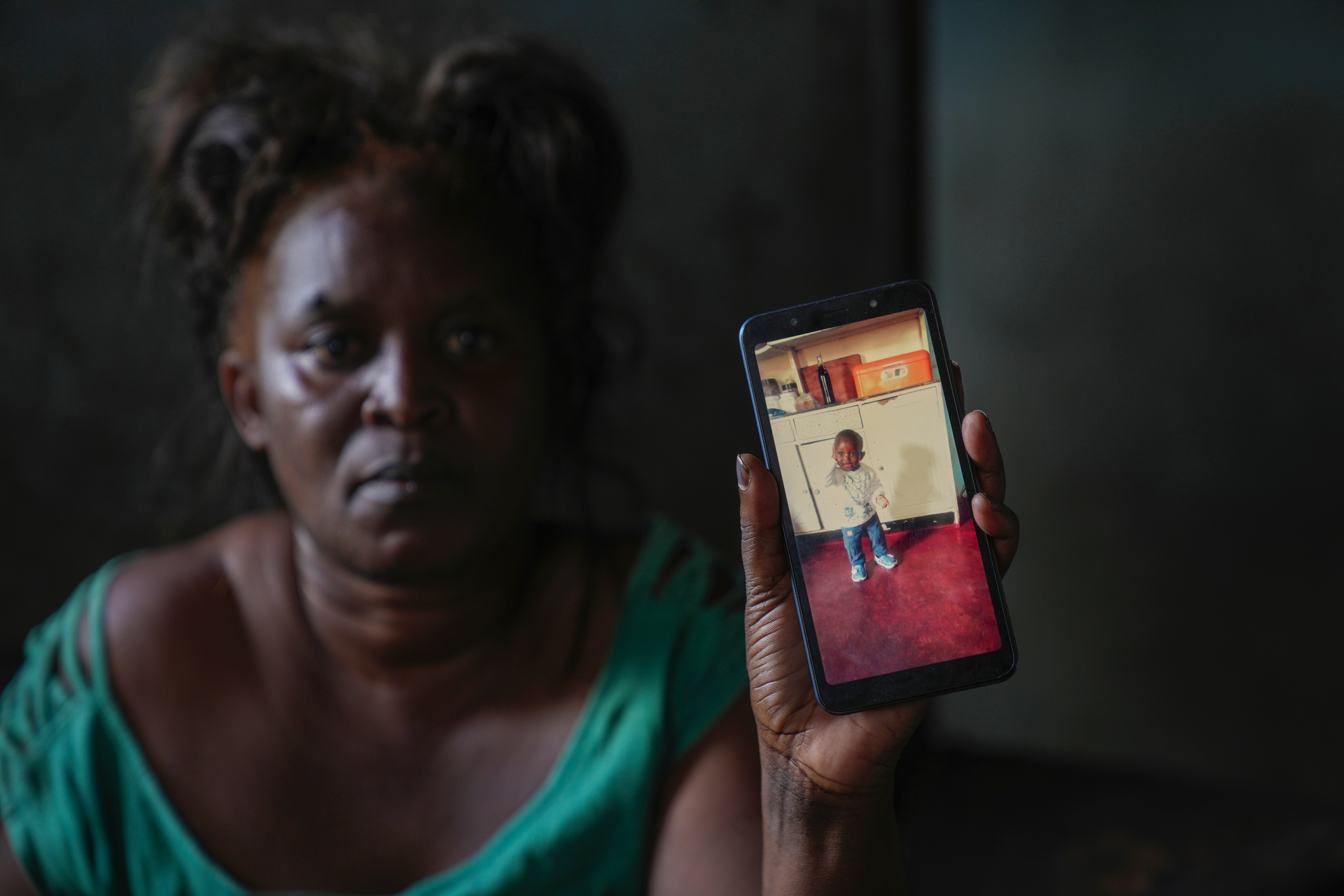 Mildred Banda displays a photo of her one-year-old son, Ndanji