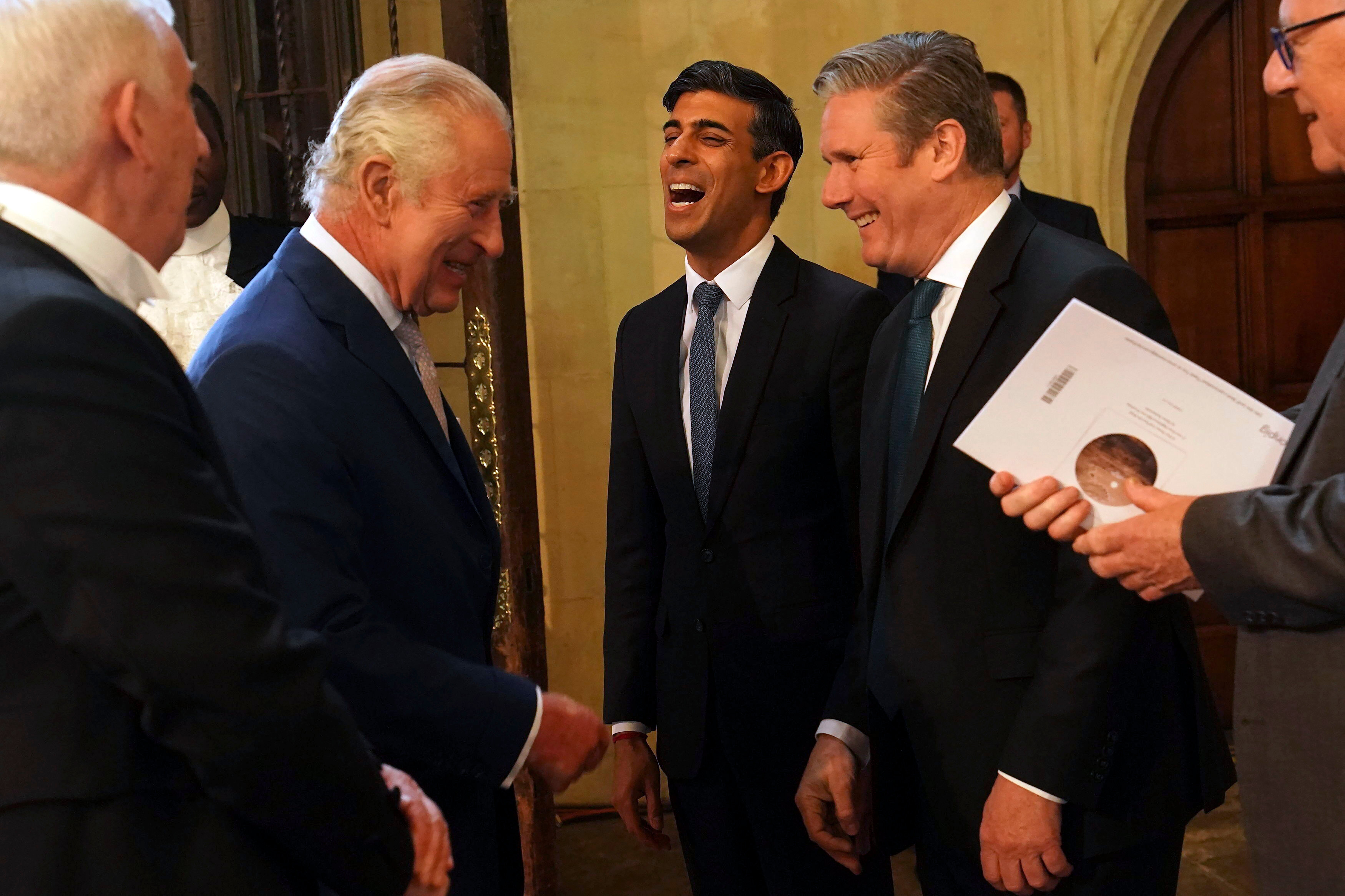 Britain’s King Charles III speaks with Sunak and Starmer