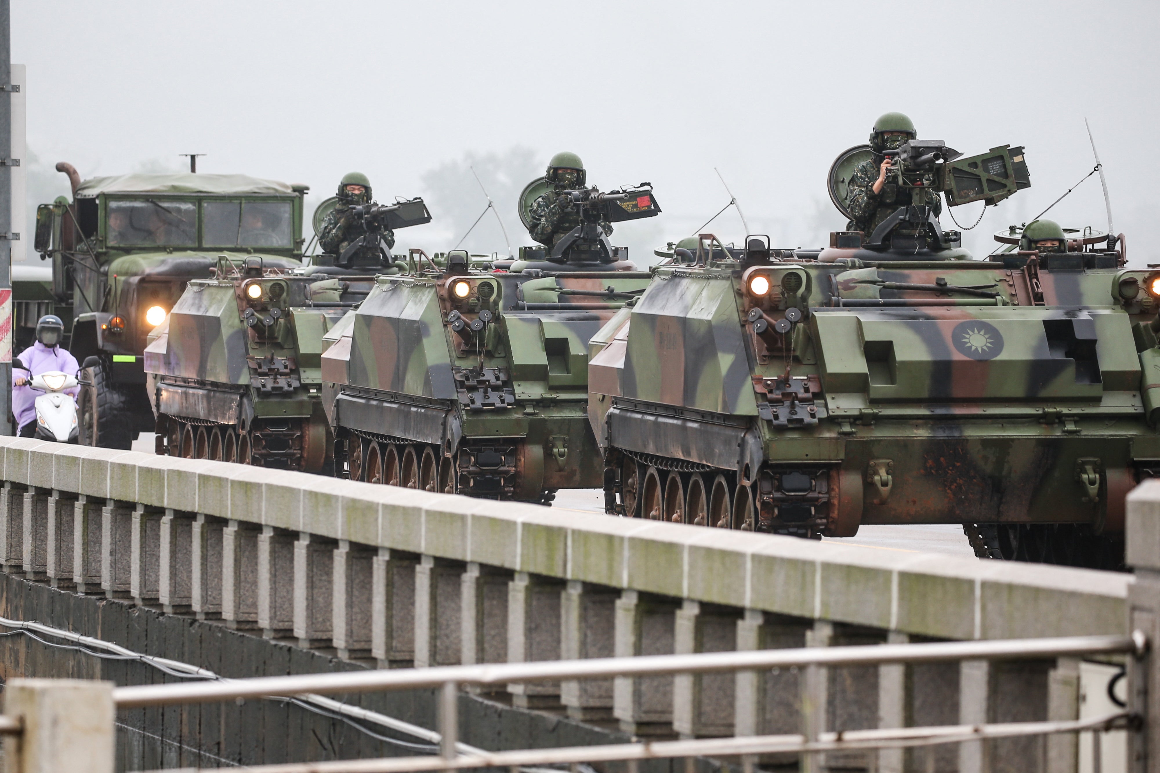 Taiwanese armoured vehicles roll down a street in Kinmen