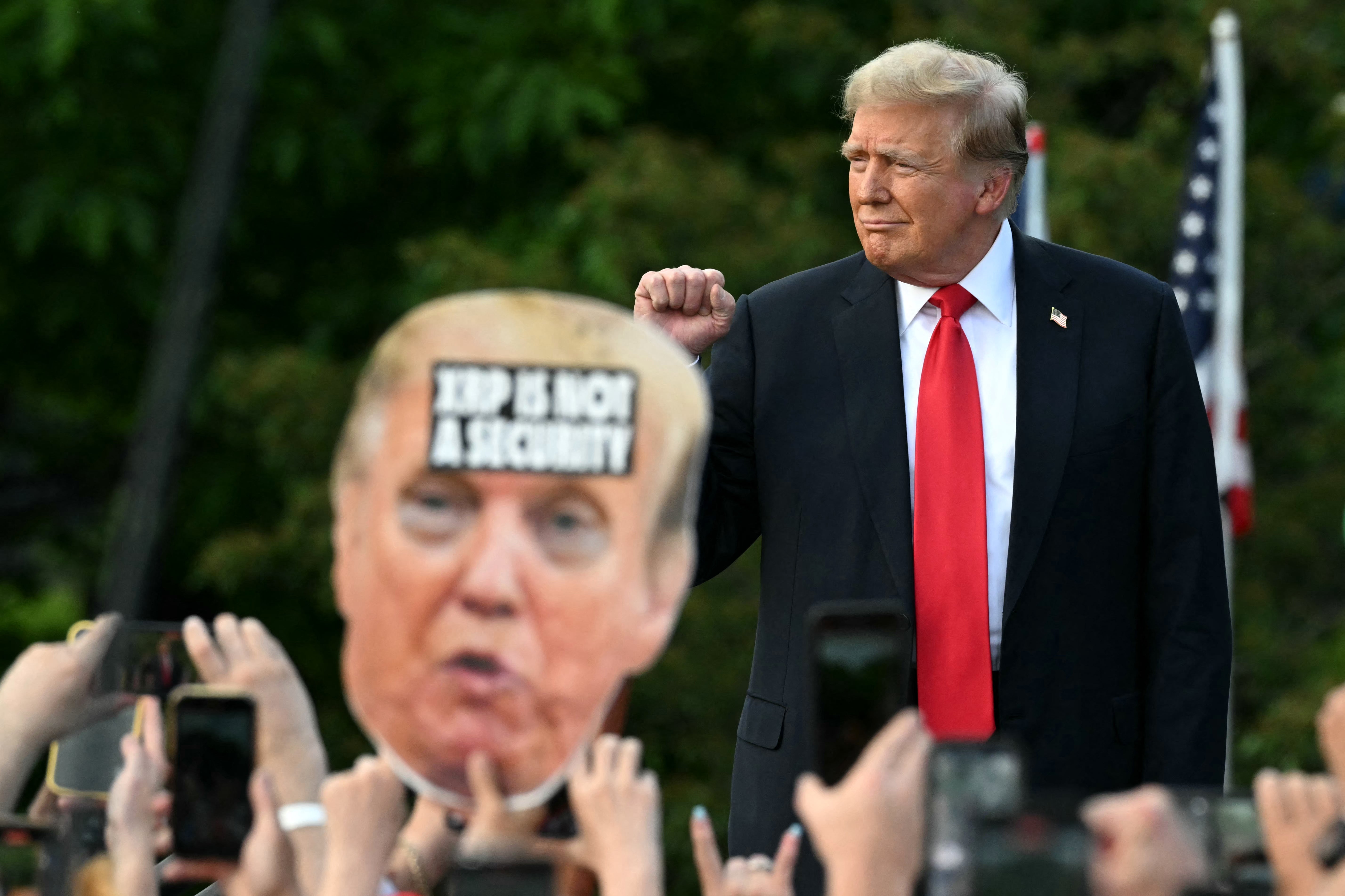 Trump walks on stage as he arrives for a campaign rally in the South Bronx in New York City on 23 May