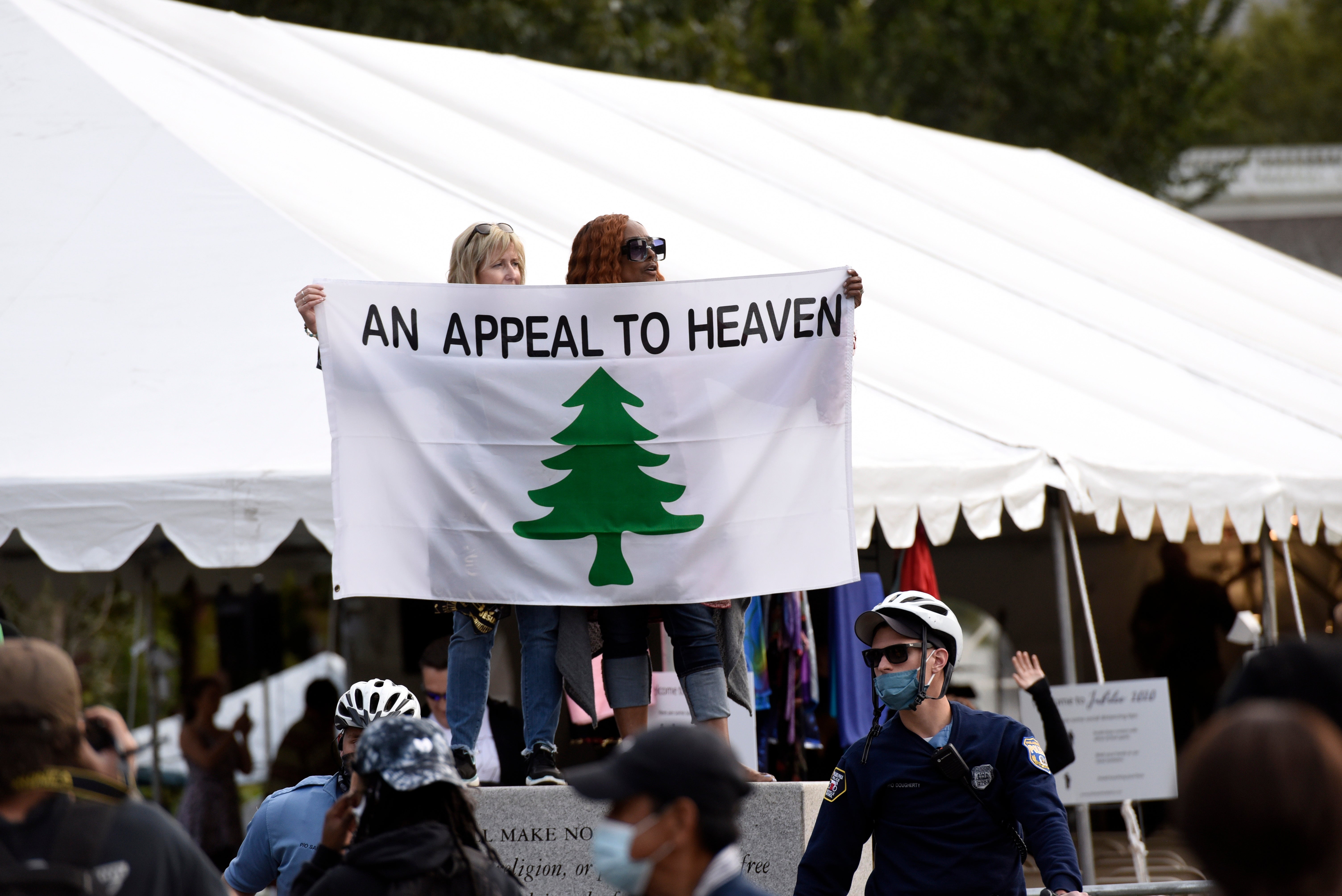 People carry an "Appeal To Heaven" flag as they gather at Independence Mall to support President Donald Trump during a visit to the National Constitution Center in Philadelphia