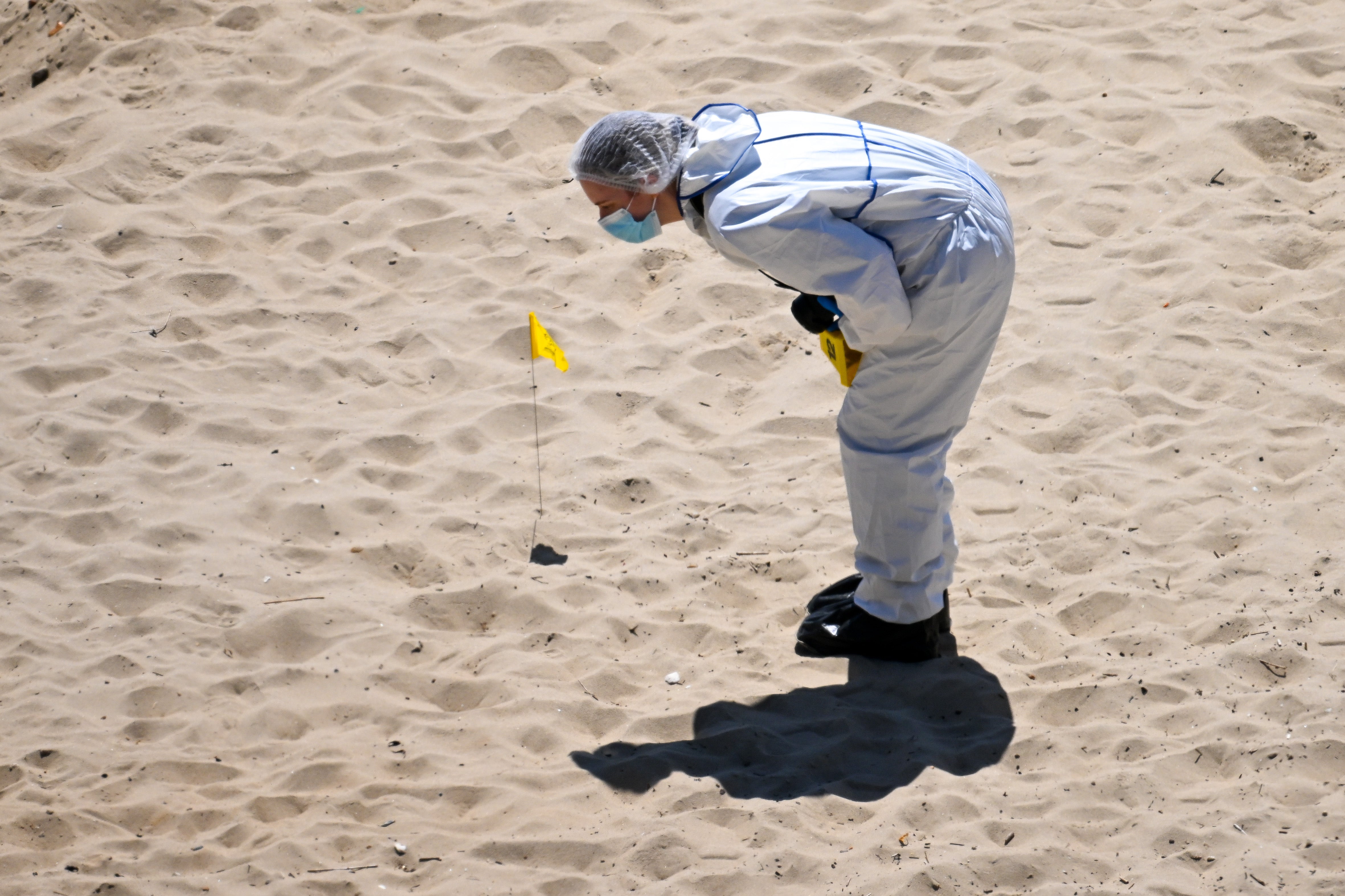 Forensic officers work at the scene of the double stabbing over the weekend