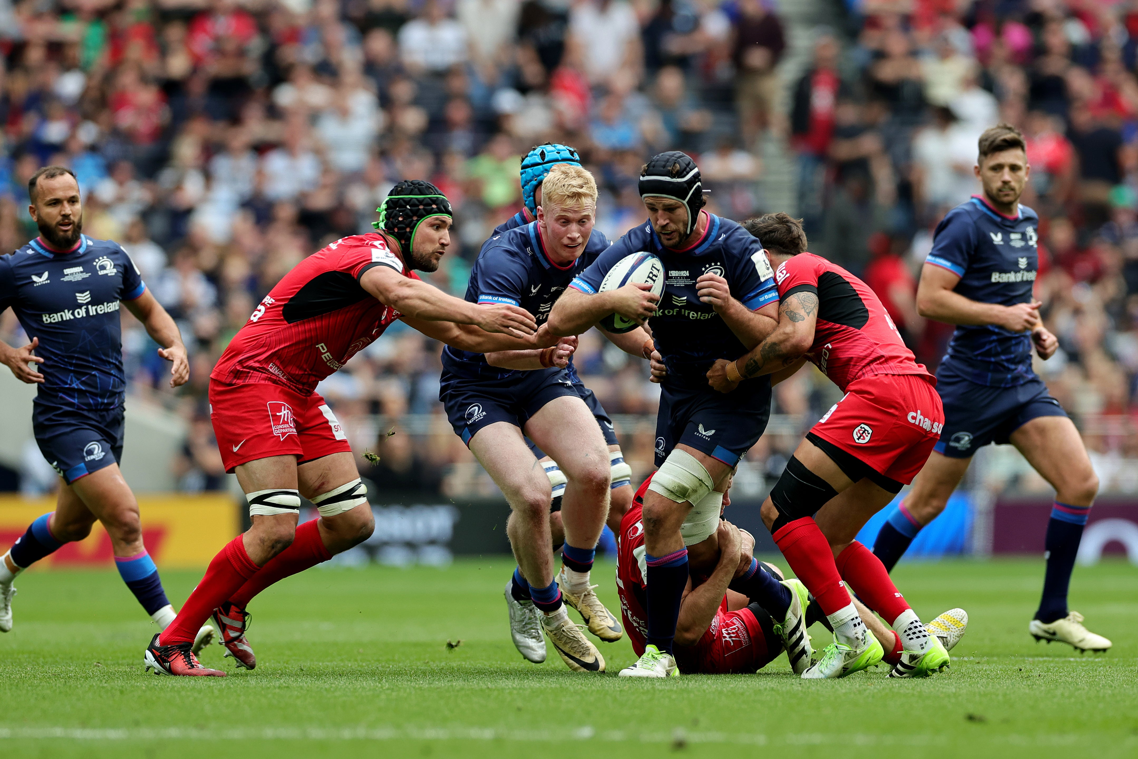 Caelan Doris of Leinster is tackled by Romain Ntamack of Stade Toulousain