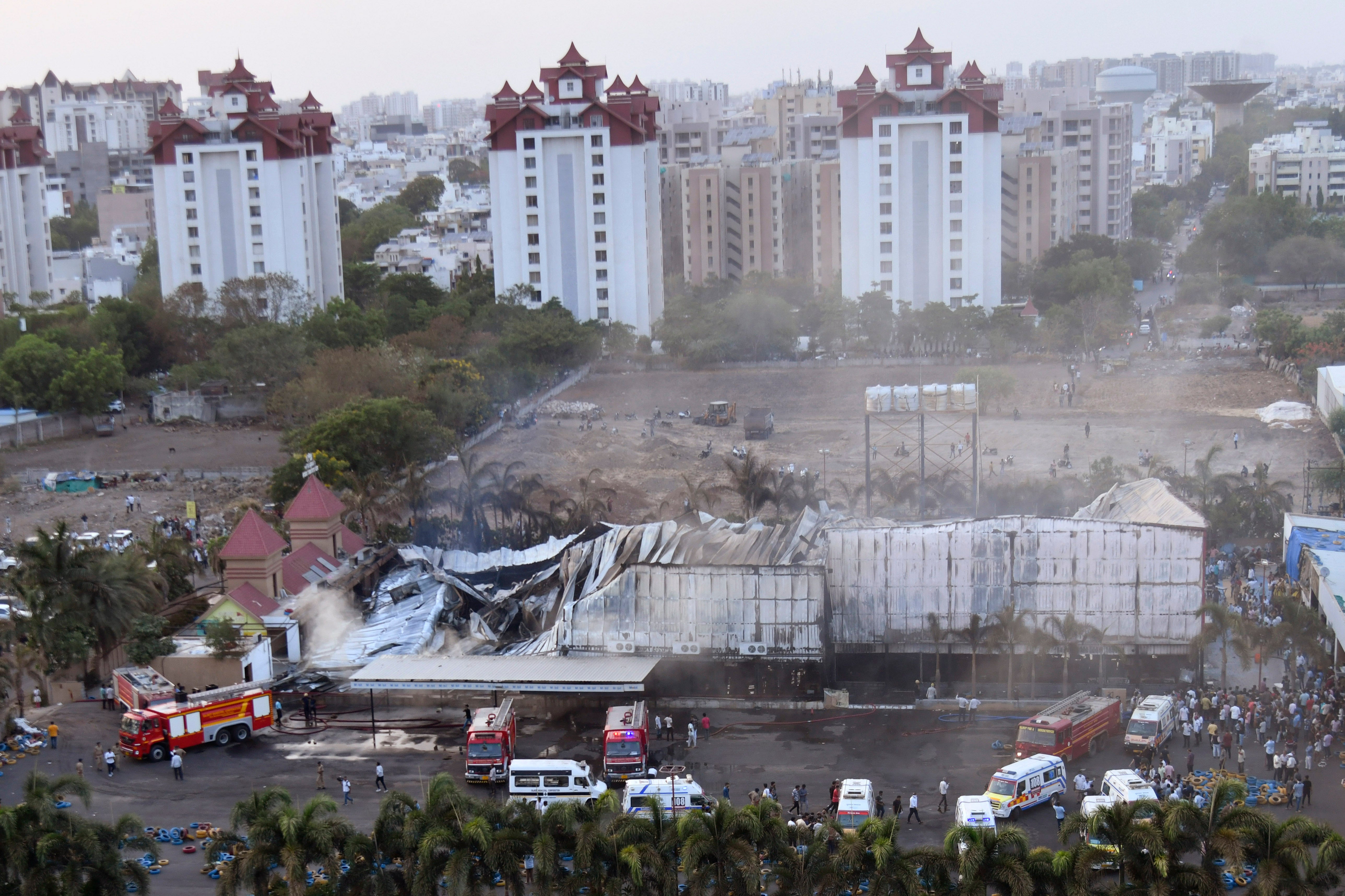 Firefighters douse a fire at an amusement park in Rajkot on Saturday