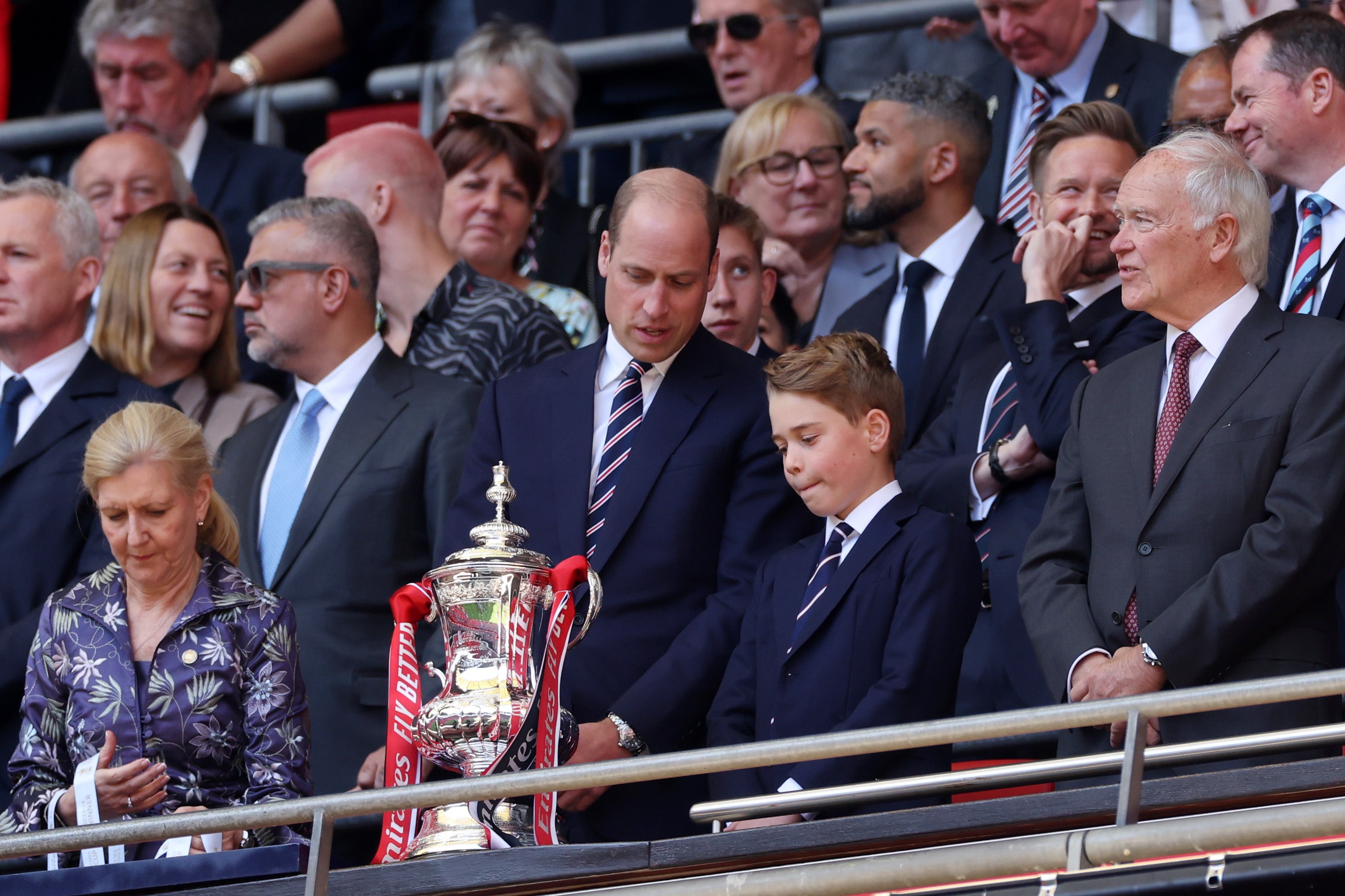 William and George eye up the trophy ahead of presenting it to the winners