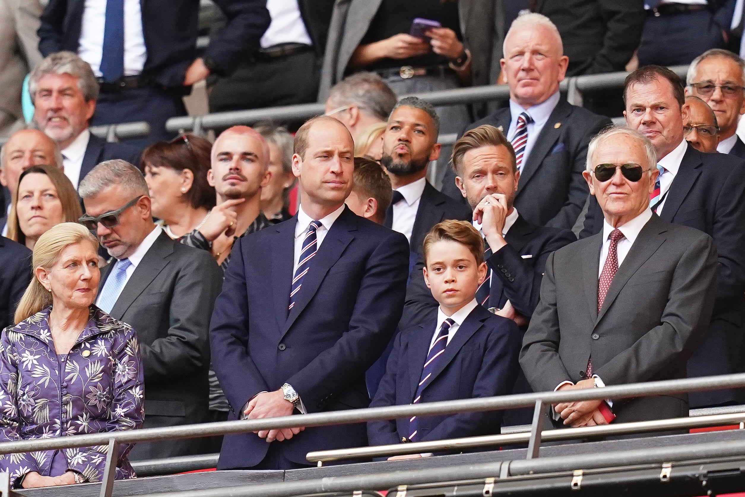 The father and son wore matching navy suits and striped ties