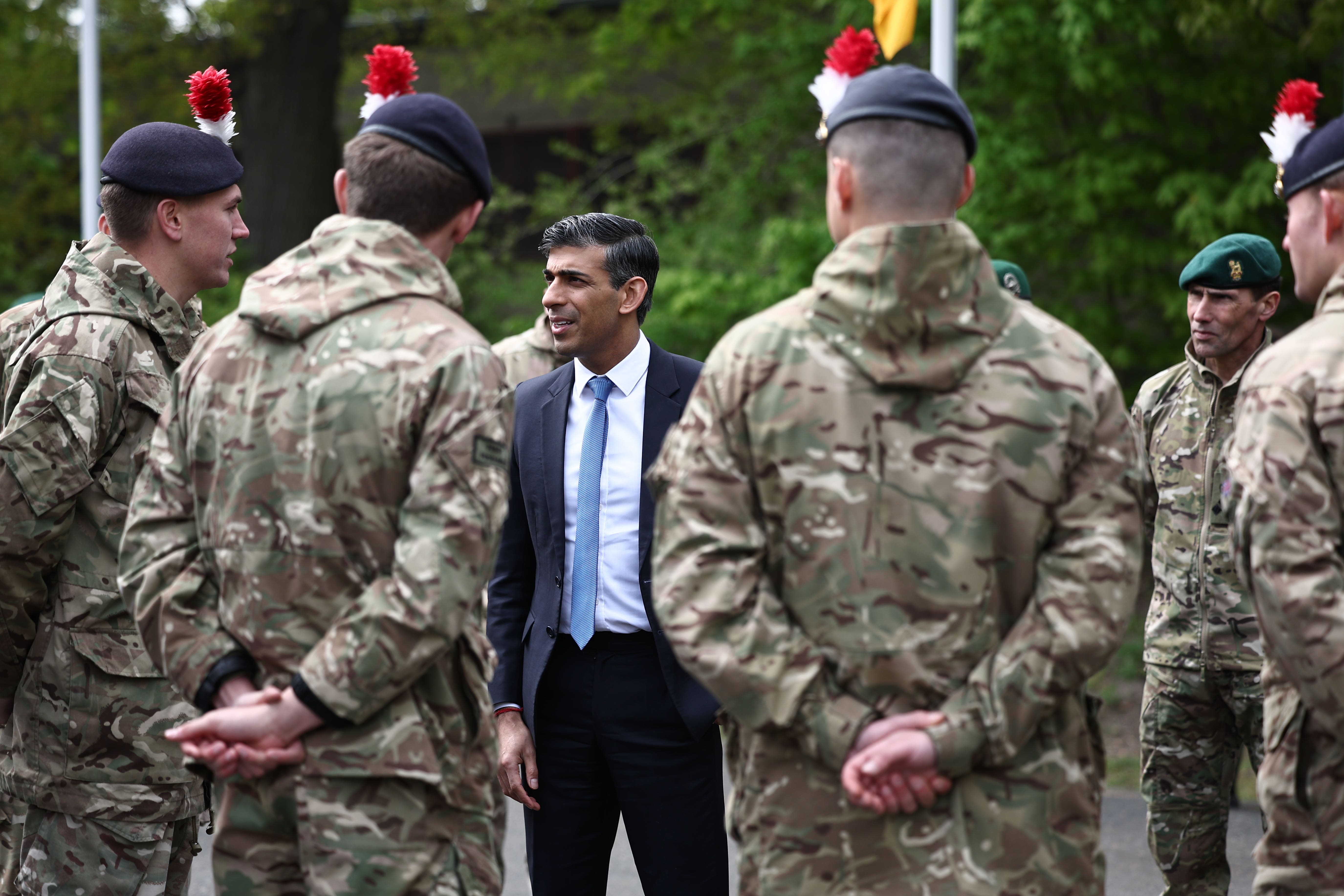 Rishi Sunak speaks with British troops in April (PA)