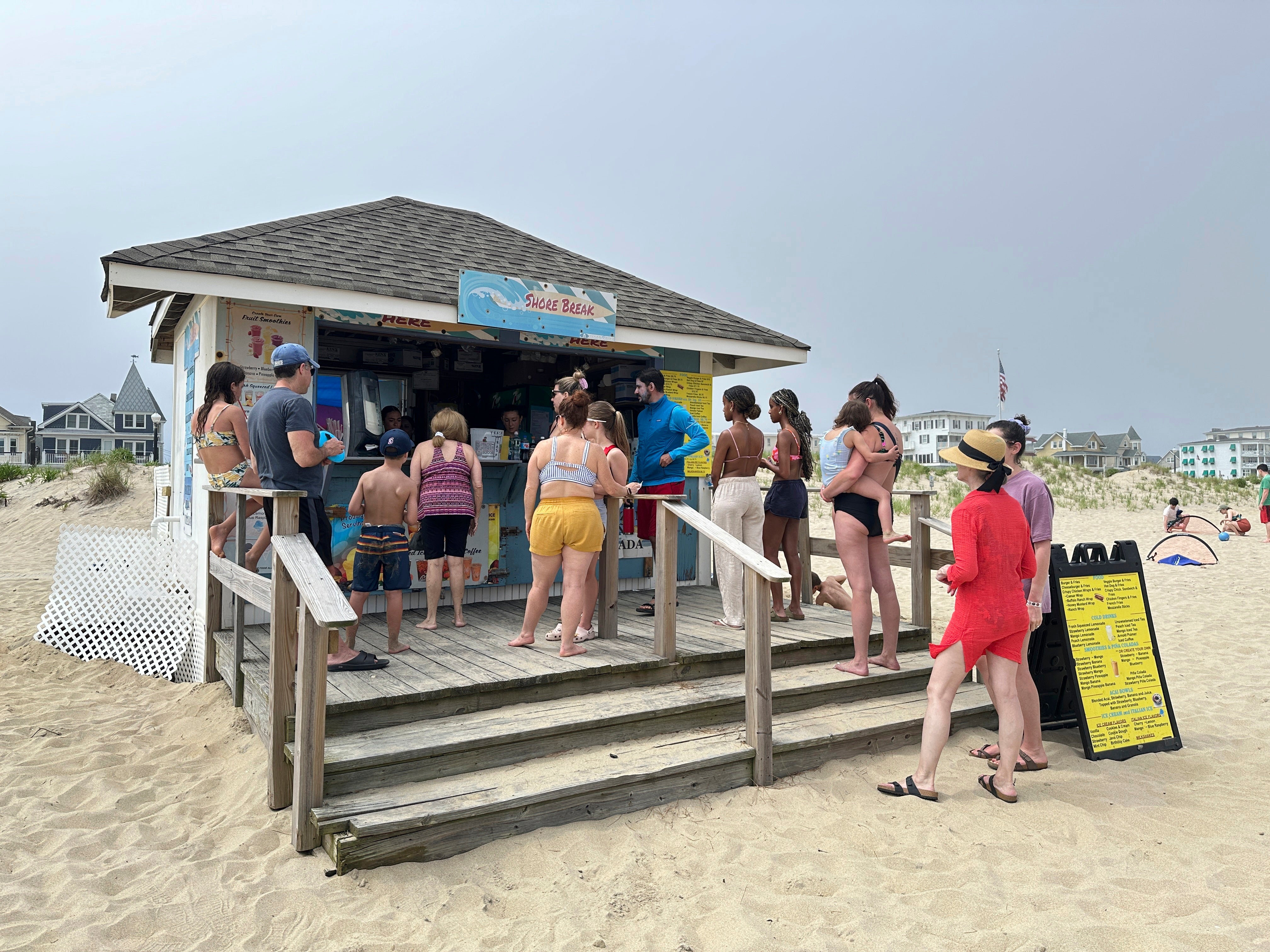 Beachgoers buy food and drinks at a concession stand on the beach at Ocean Grove, N.J., on Sunday, May 26, 2024