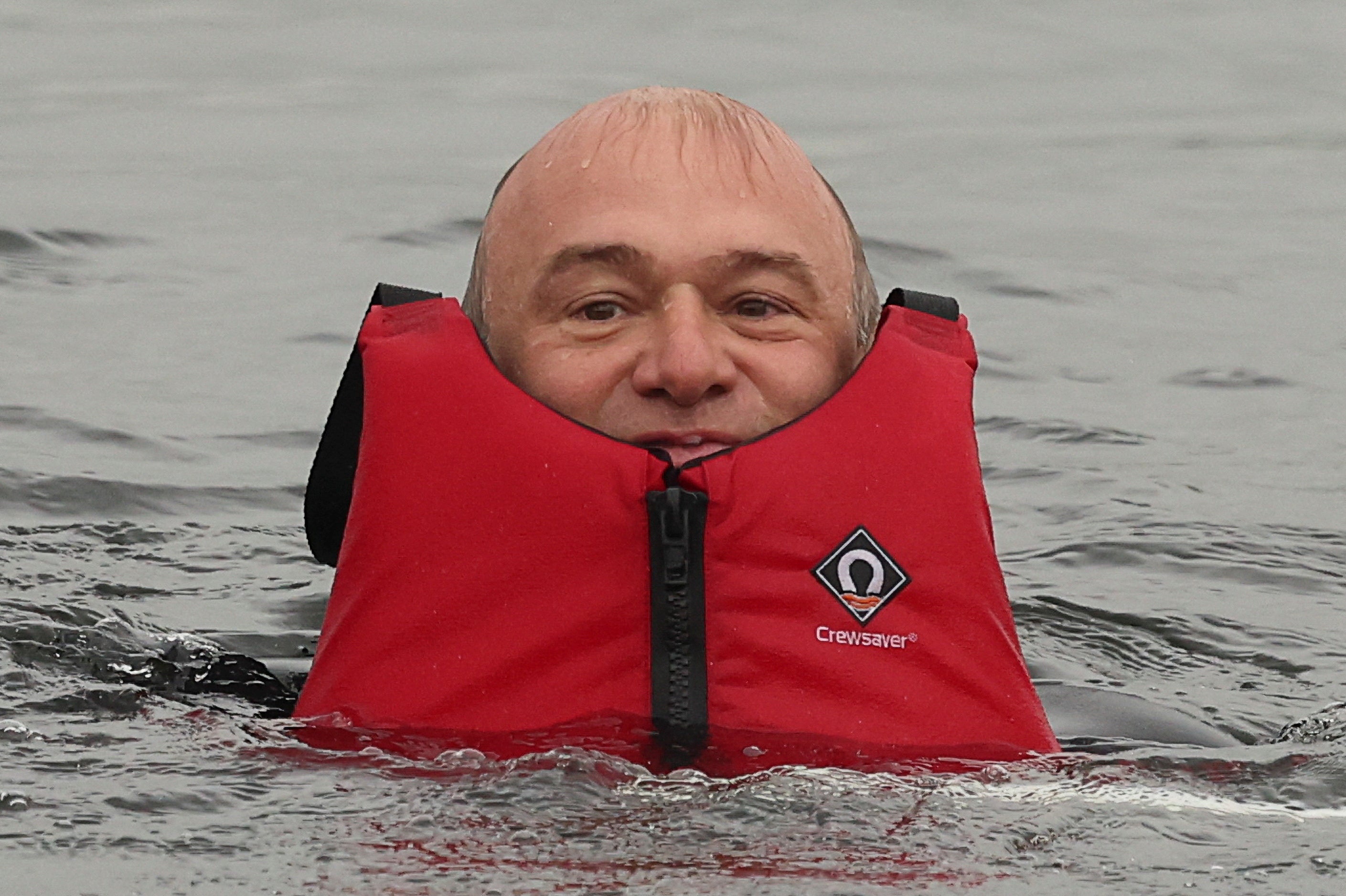 Up to his neck in... the water crisis: Ed Davey in Lake Windermere this week