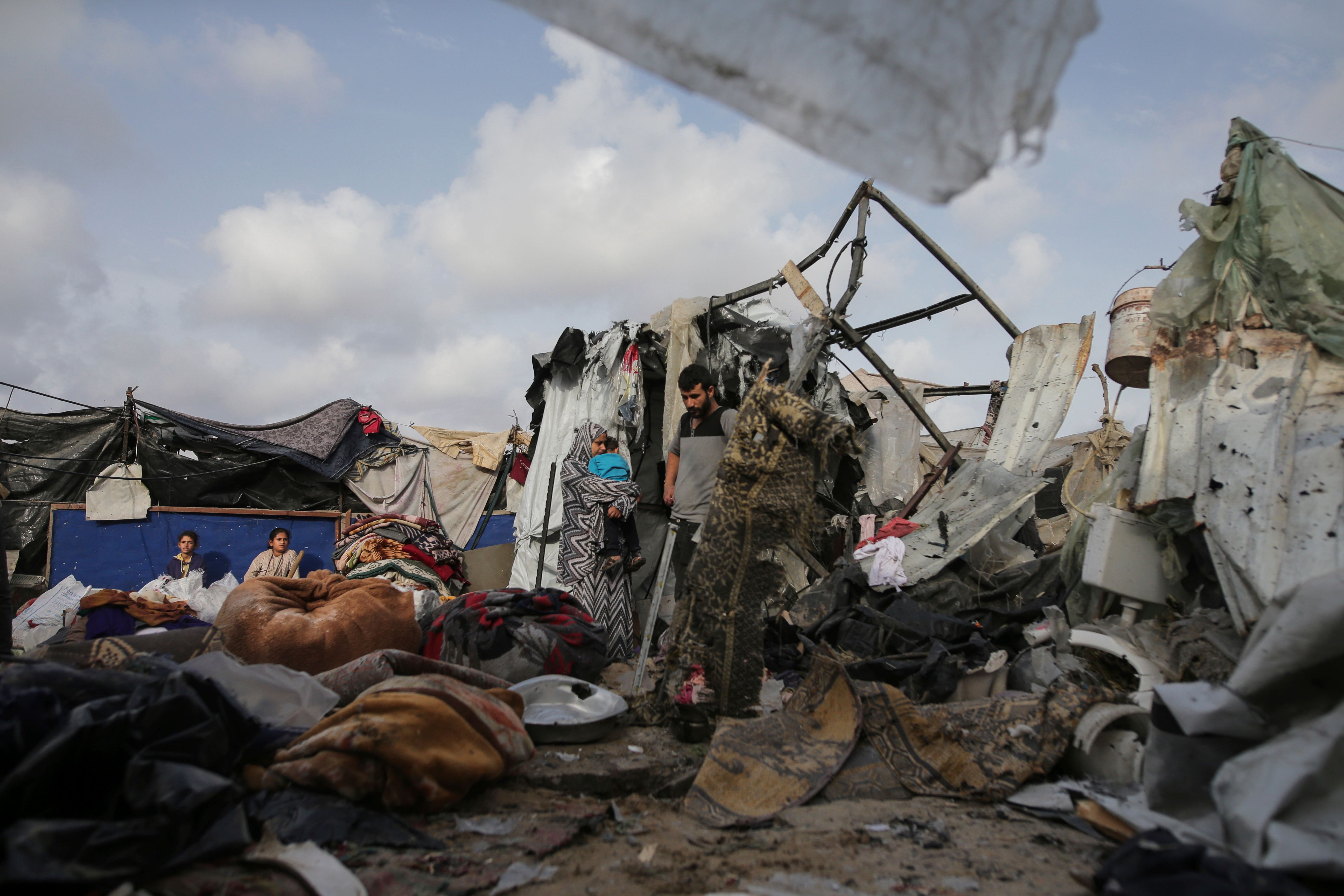 Palestinians inspect their tents destroyed by Israel’s bombardment (Jehad Alshrafi/AP)