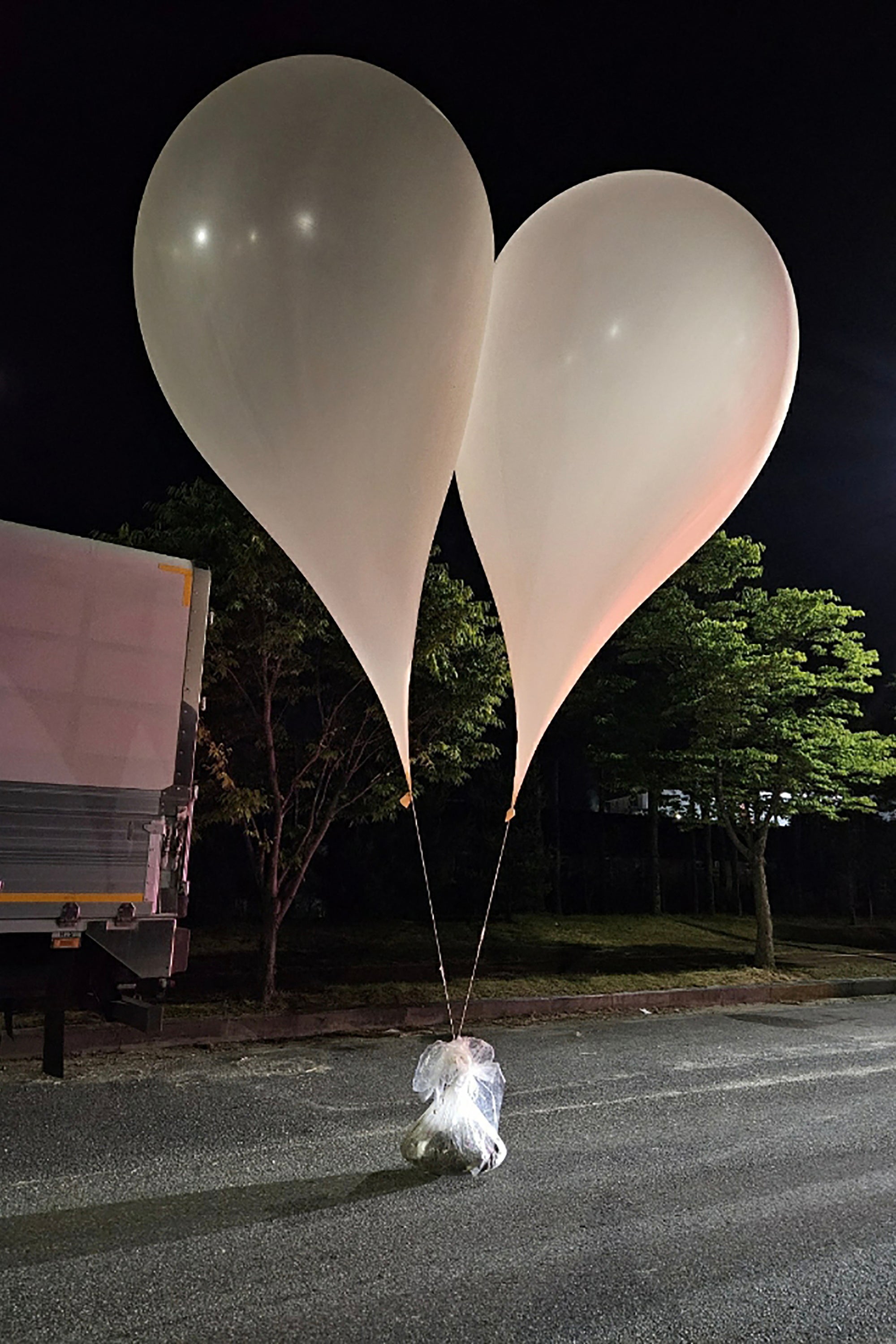 A picture released by the South Korean Defence Ministry on 29 May shows objects thought to be North Korean propaganda material attached to balloons on a street in Chungnam province