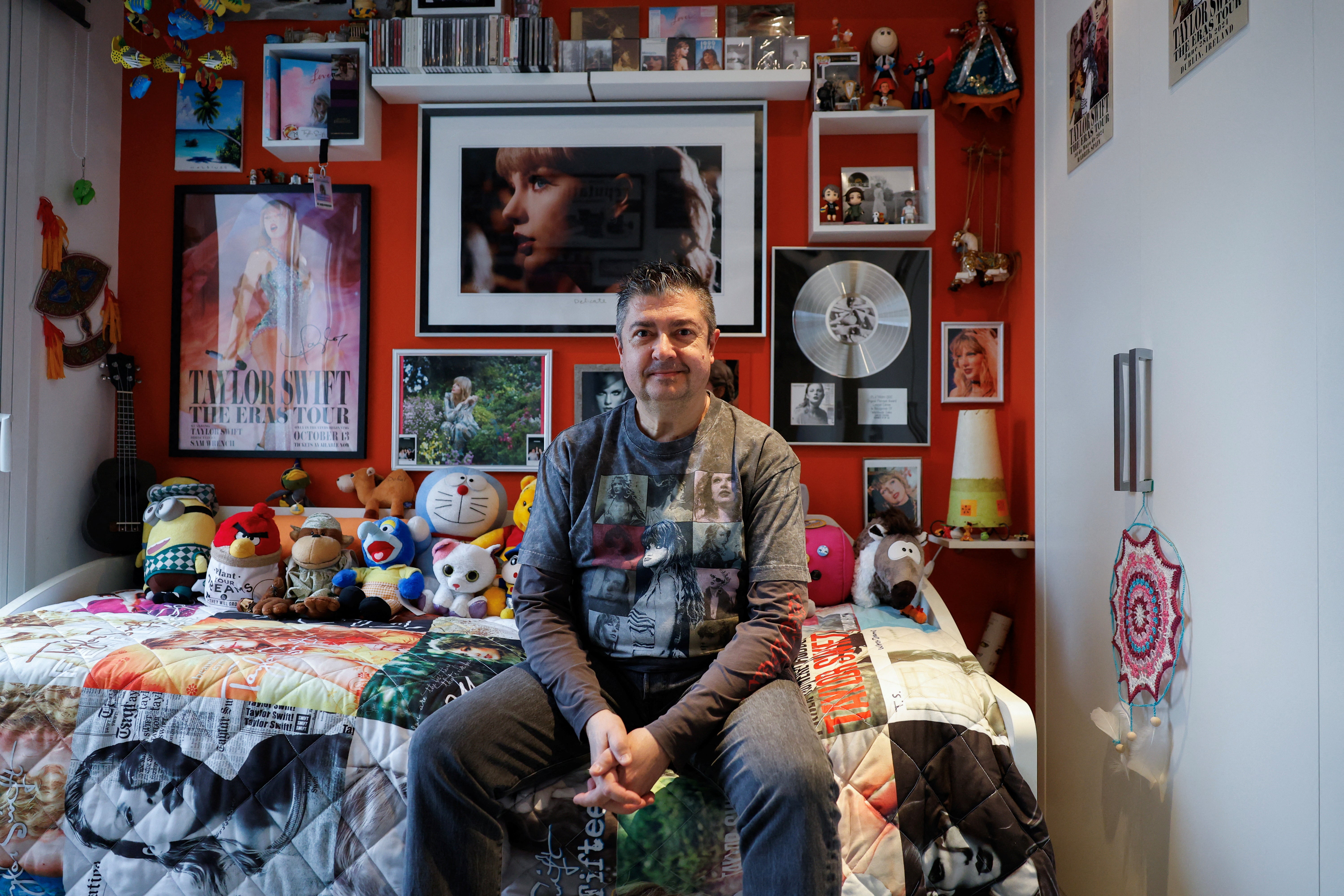 Roberto Santos, 55, a Spanish superfan who is part of a select list of fans who receives exclusive gifts from the pop icon, poses in his ‘Taylor Swift shrine' in his home in Madrid, Spain