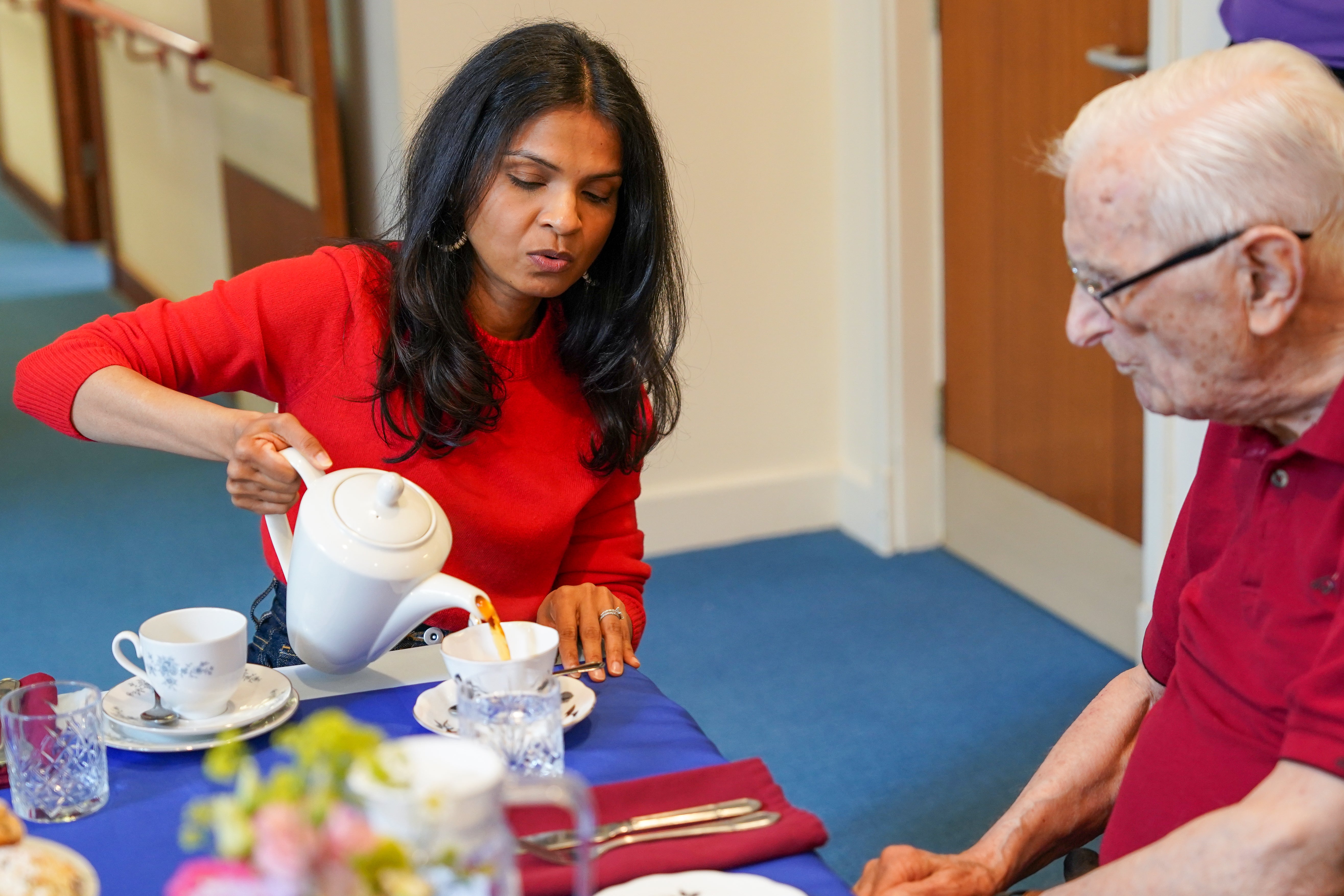 The prime minister’s wife pours the tea