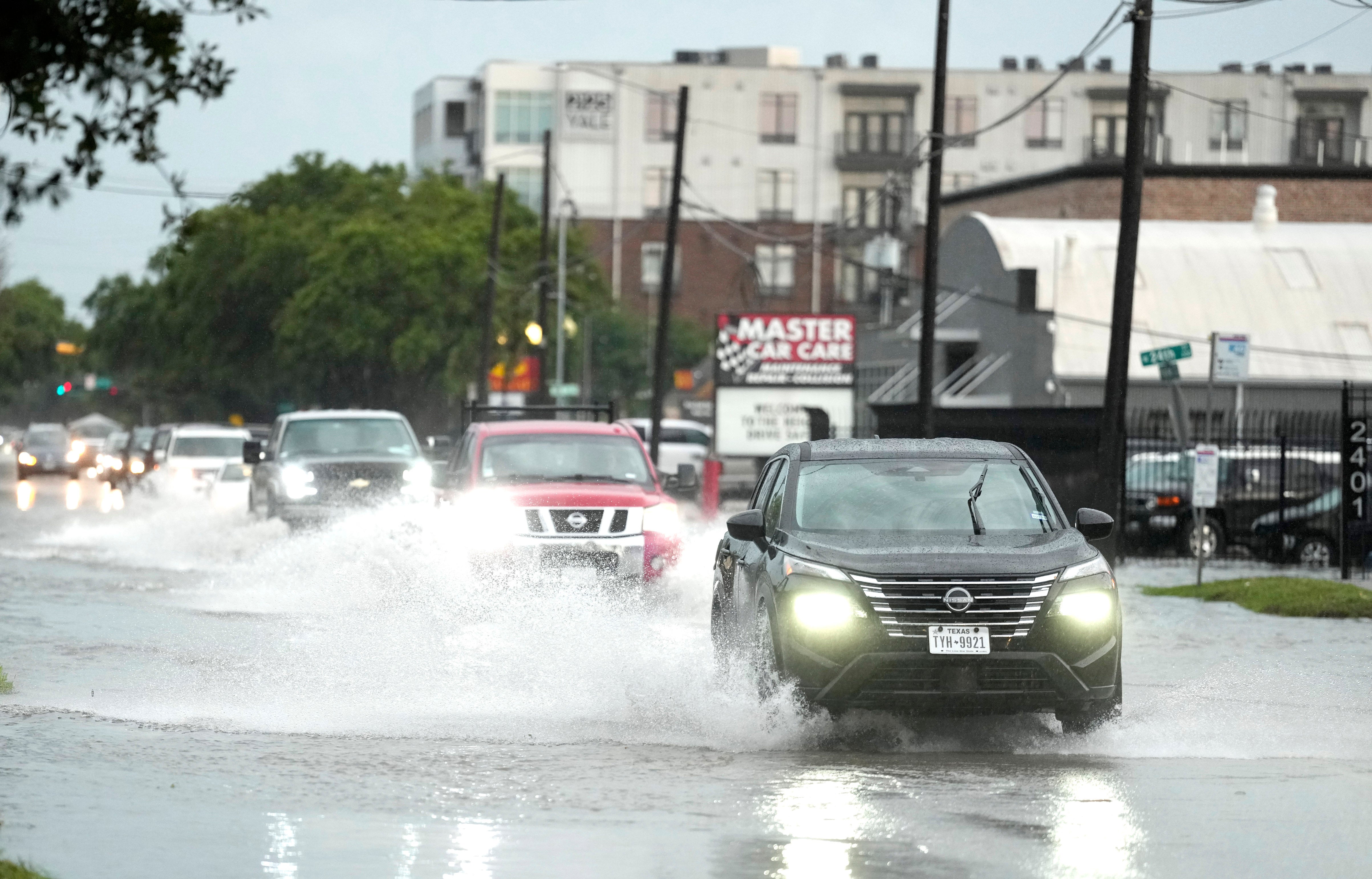 Drivers navigate high water on a Houston, Texas street as severe thunderstorms pelt the state