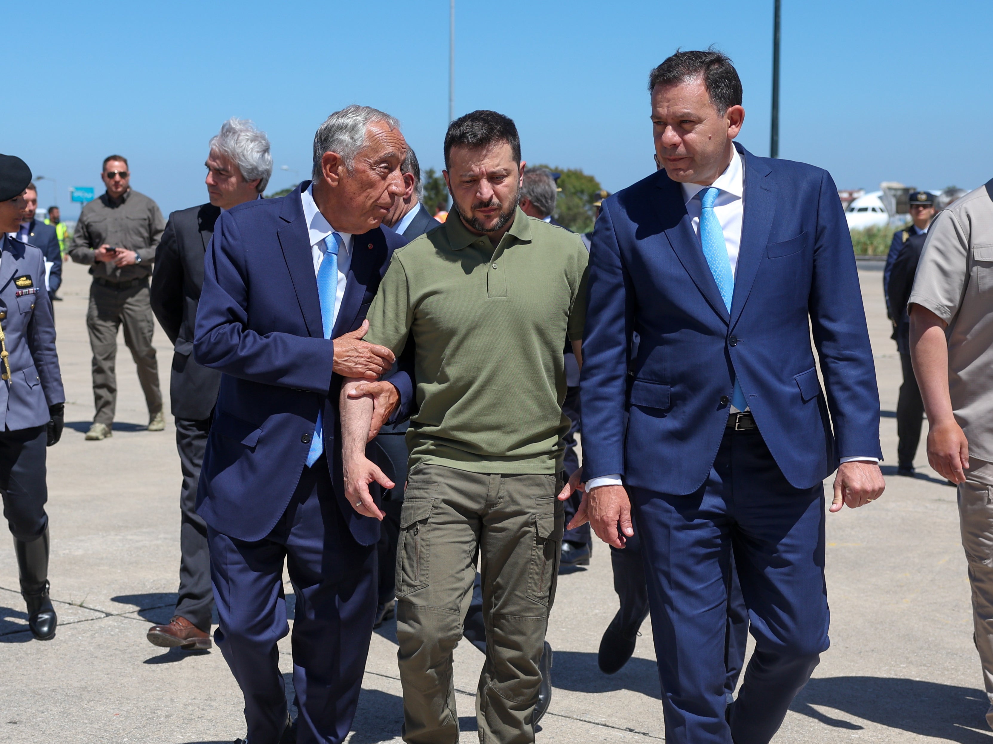 Portuguese head of state Marcelo Rebelo de Sousa, left, and Portuguese prime minister Luis Montenegro, right, welcome Ukraine's President Volodymyr Zelensky, centre, on his arrival at Figo Maduro air base