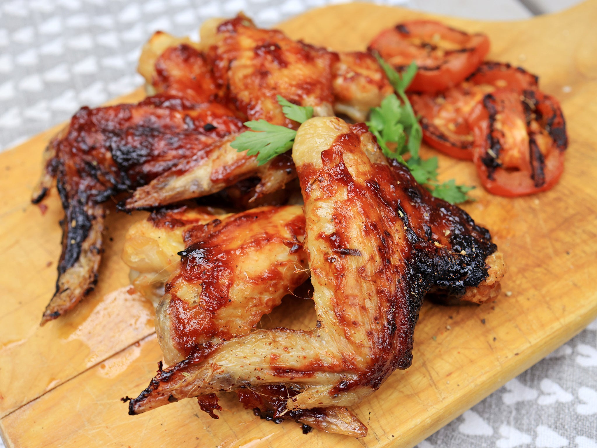 Sizzling sticky BBQ chicken thighs glazed with homemade sauce and garnished with rocket leaves