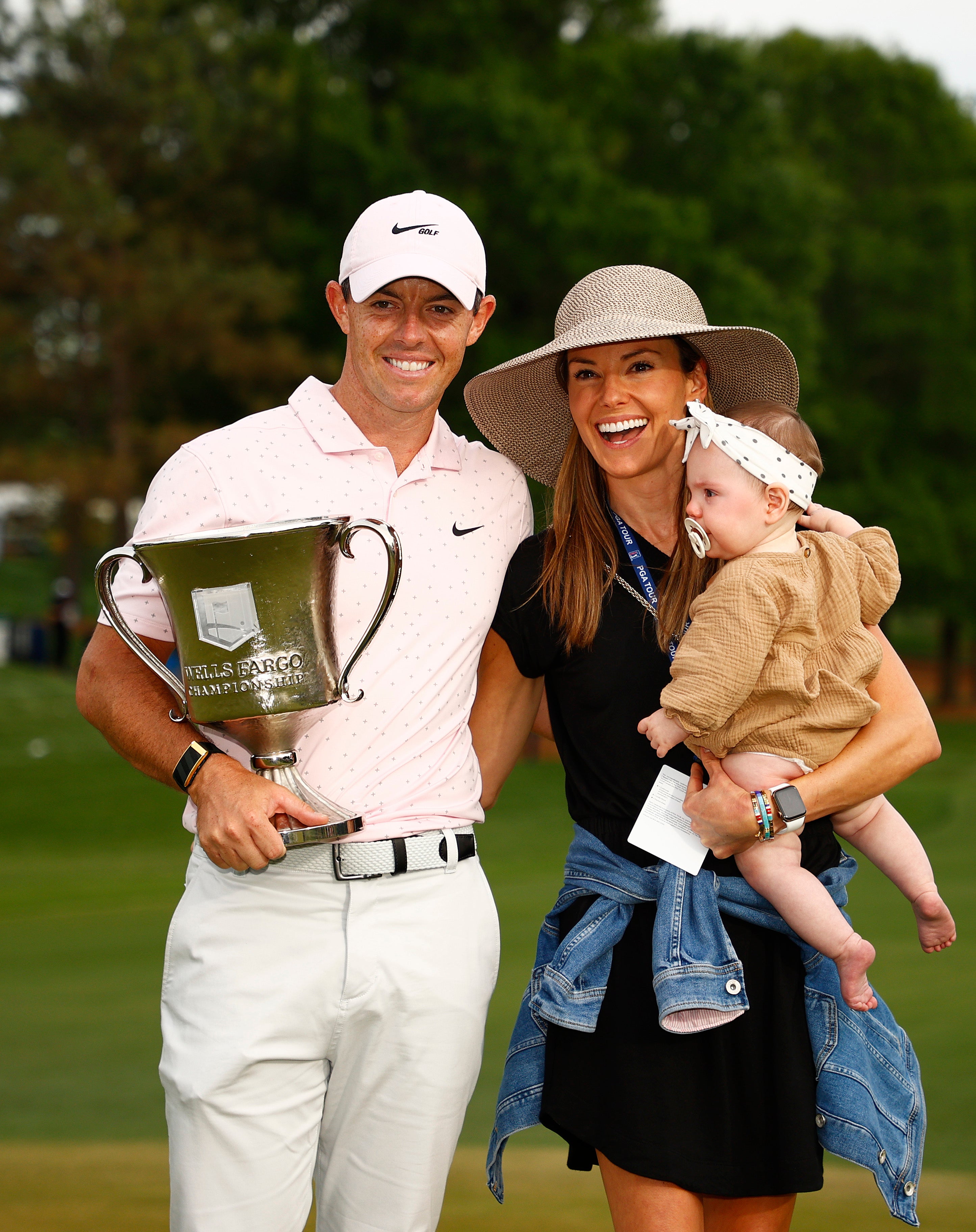 Rory McIlroy of Northern Ireland celebrates with his wife Erica and daughter Poppy after winning the 2021 Wells Fargo Championship