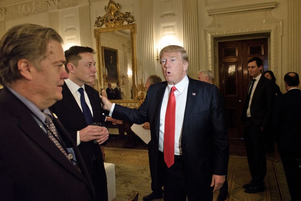 Bannon with Donald Trump and Elon Musk in the White House at an event in 2017