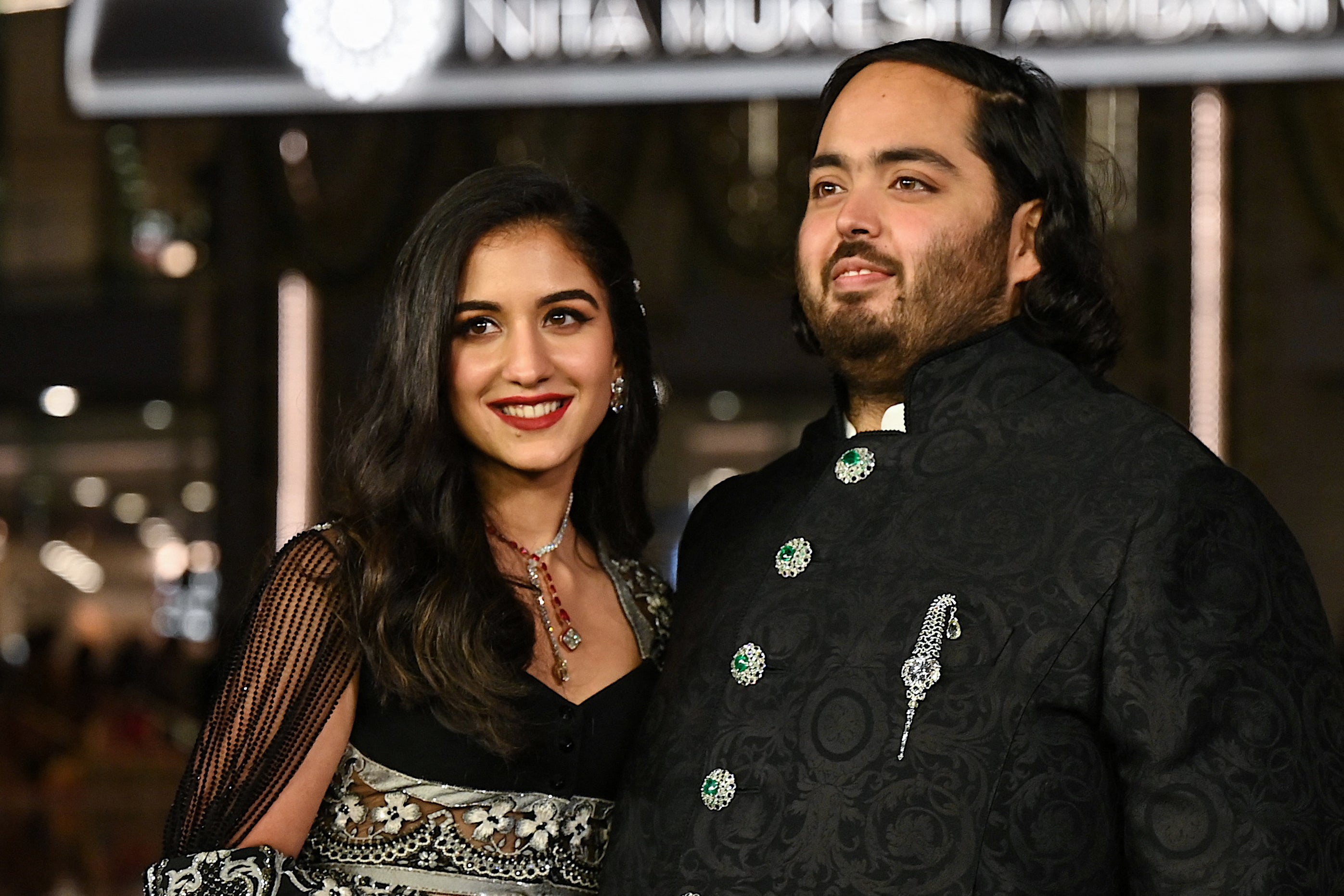 Anant Ambani (R), son of Indian businessman Mukesh Dhirubhai Amani, and his wife Radhika Merchant pose for pictures during the inauguration of the Nita Mukesh Ambani Cultural Centre (NMACC) at the Jio World Centre (JWC) in Mumbai