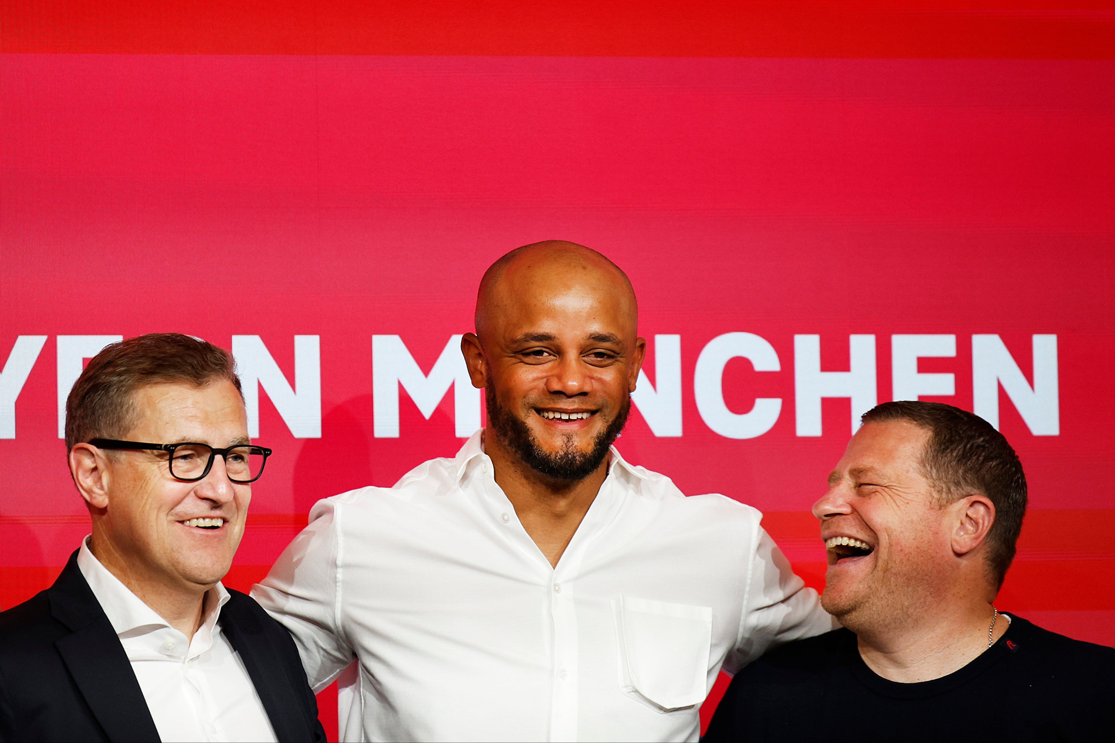 Bayern Munich CEO Jan-Christian Dreesen, left, and sporting director Max Eberl, right, unveil new manager Vincent Kompany