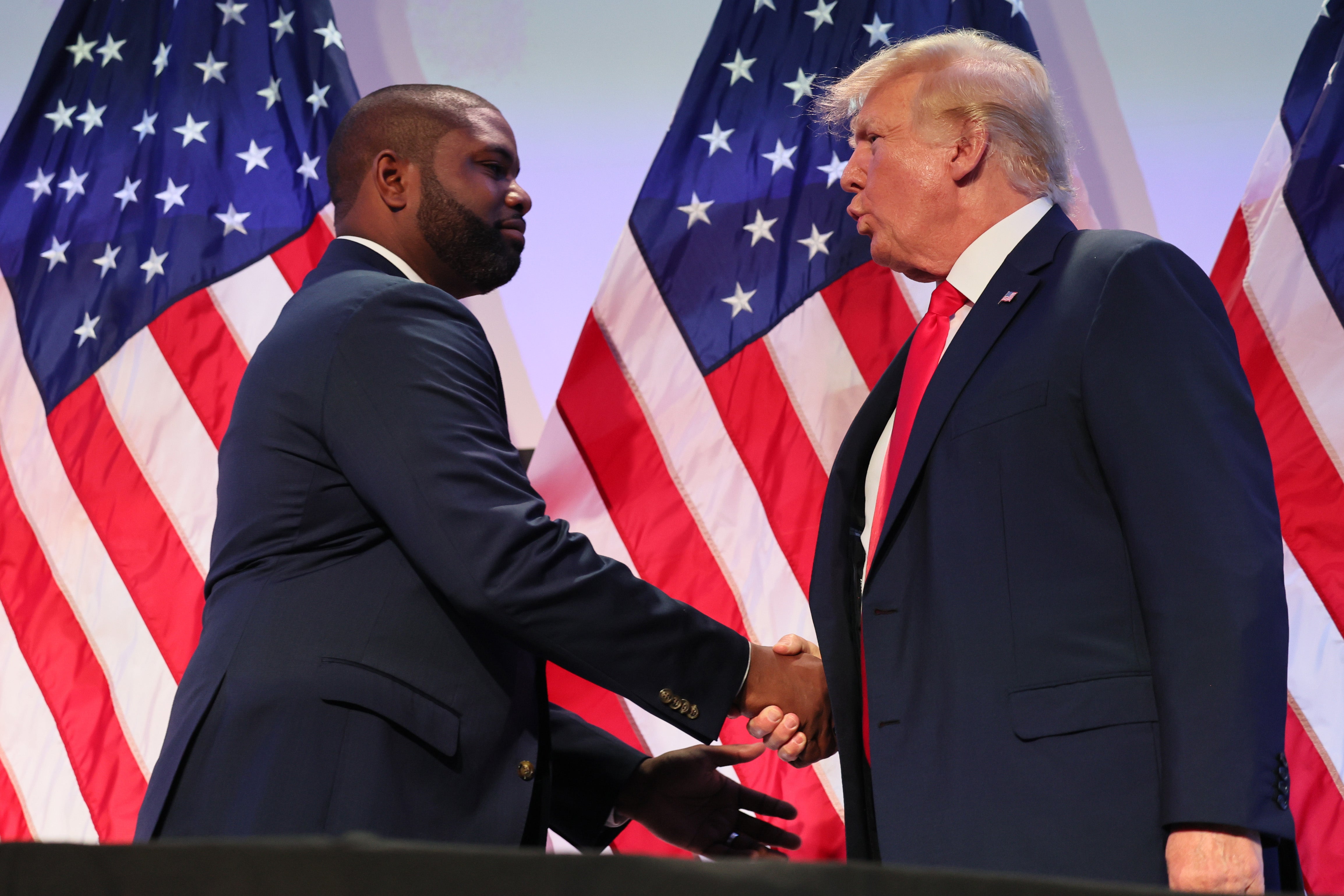 Byron Donalds shakes hands with Donald Trump during the Moms for Liberty Joyful Warriors national summit at the Philadelphia Marriott Downtown on June 30, 2023 in Philadelphia, Pennsylvania