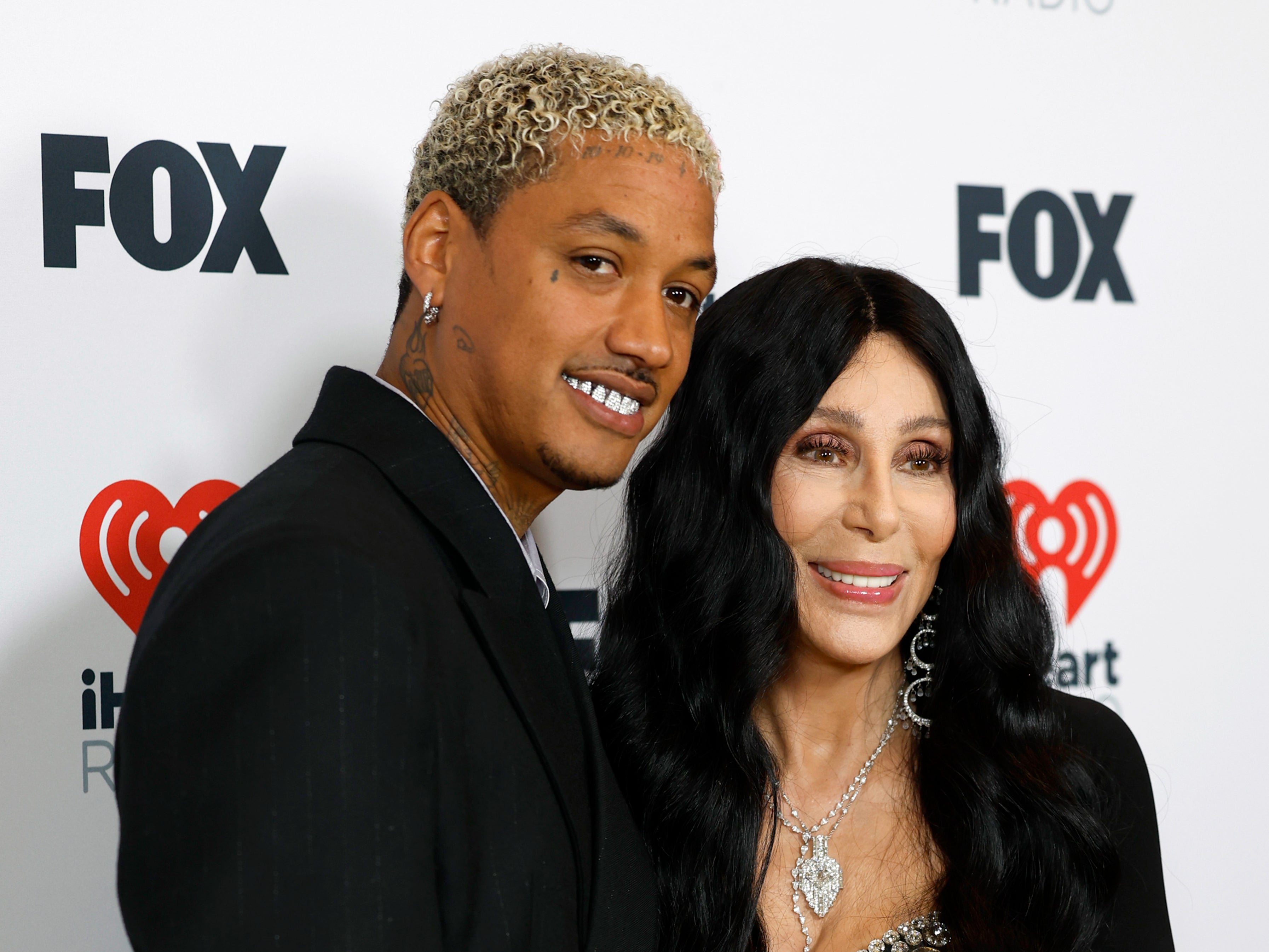 Alexander “AE” Edwards and Cher pose in the press room during the 2024 iHeartRadio Music Awards at Dolby Theatre on 1 April 2024 in Hollywood, California ( Getty Images )